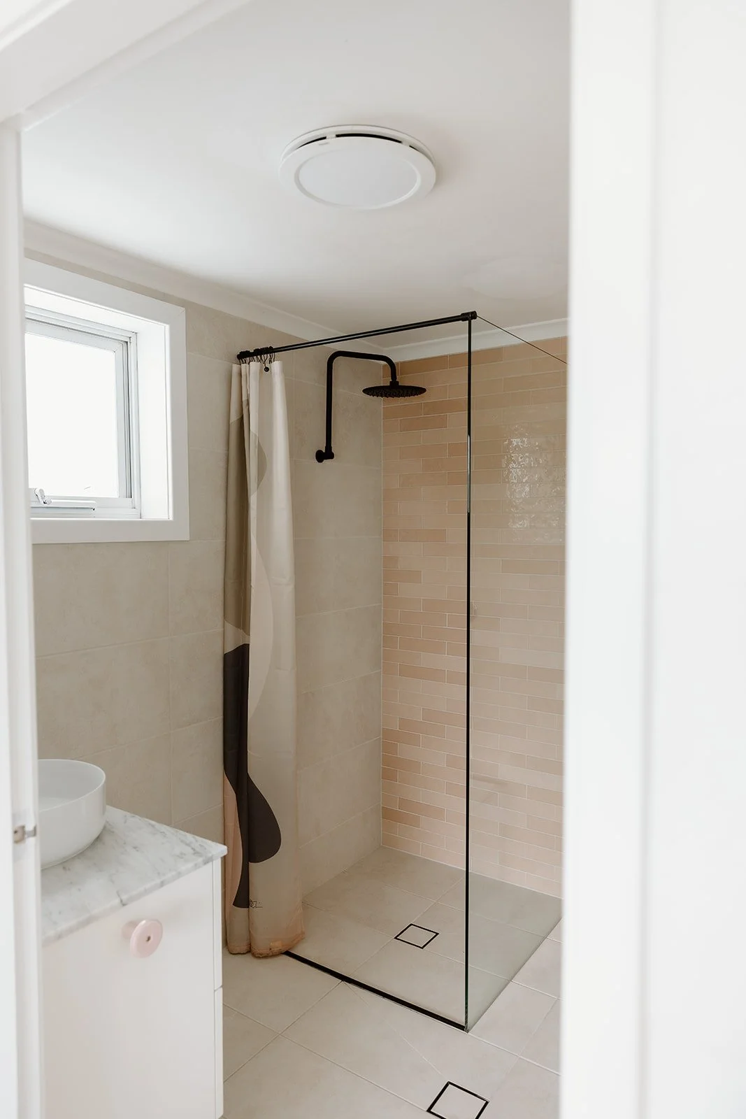 Bathroom renovation Wamberal Central Coast with stone finishes and soft neutral palette.