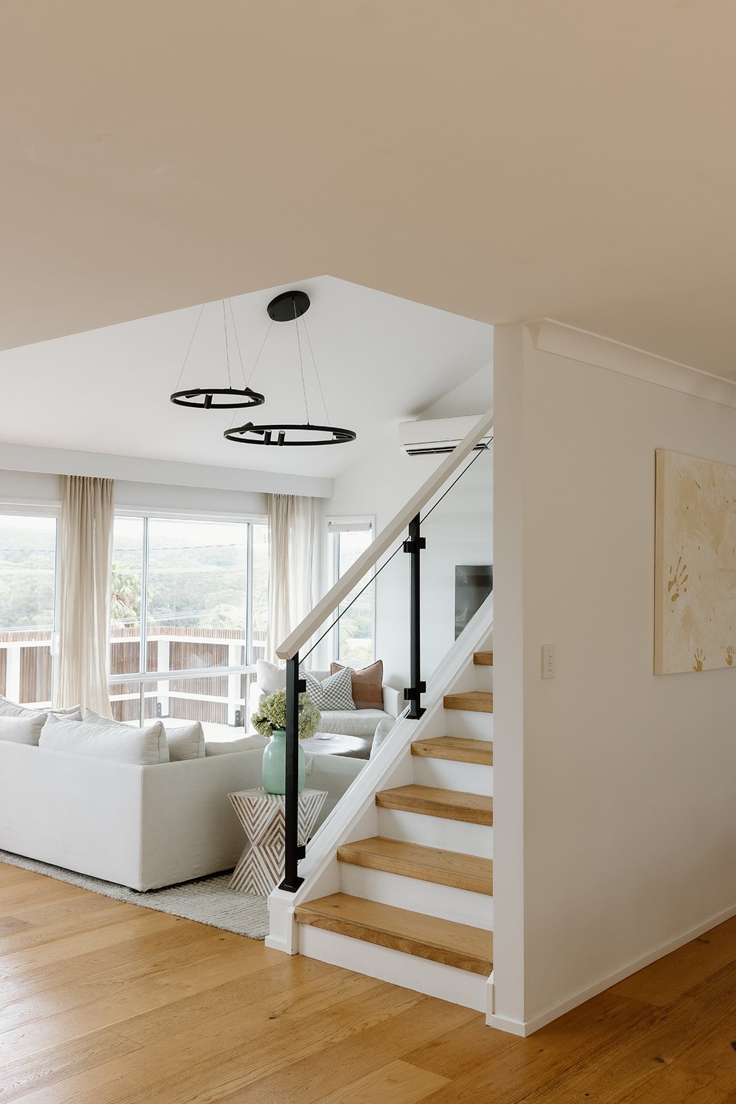 Living and dining space Wamberal Central Coast with natural materials and warm tones.