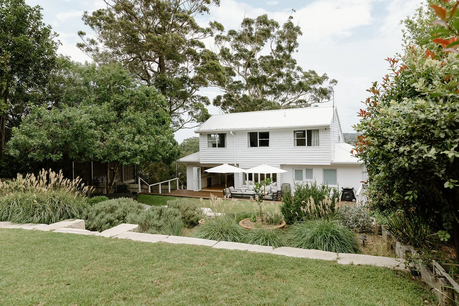 Outdoor entertaining area Wamberal Central Coast with natural landscaping and stone elements.