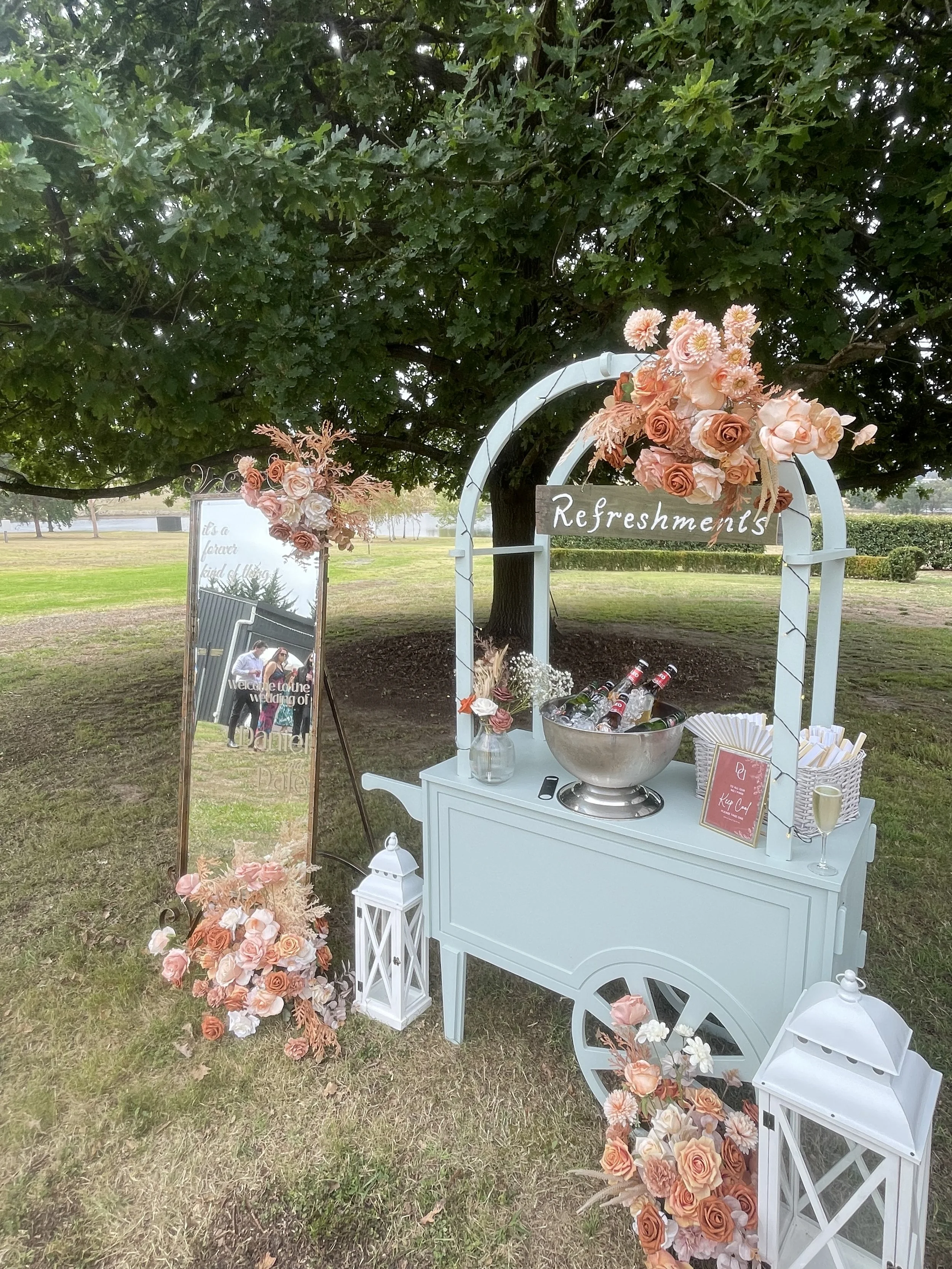 Sage green collapsible cart with long brass handle and cream fringe canopy. Ideal for styled pop-ups, wedding bars, and market displays. Click-together design, available to hire in Melbourne.