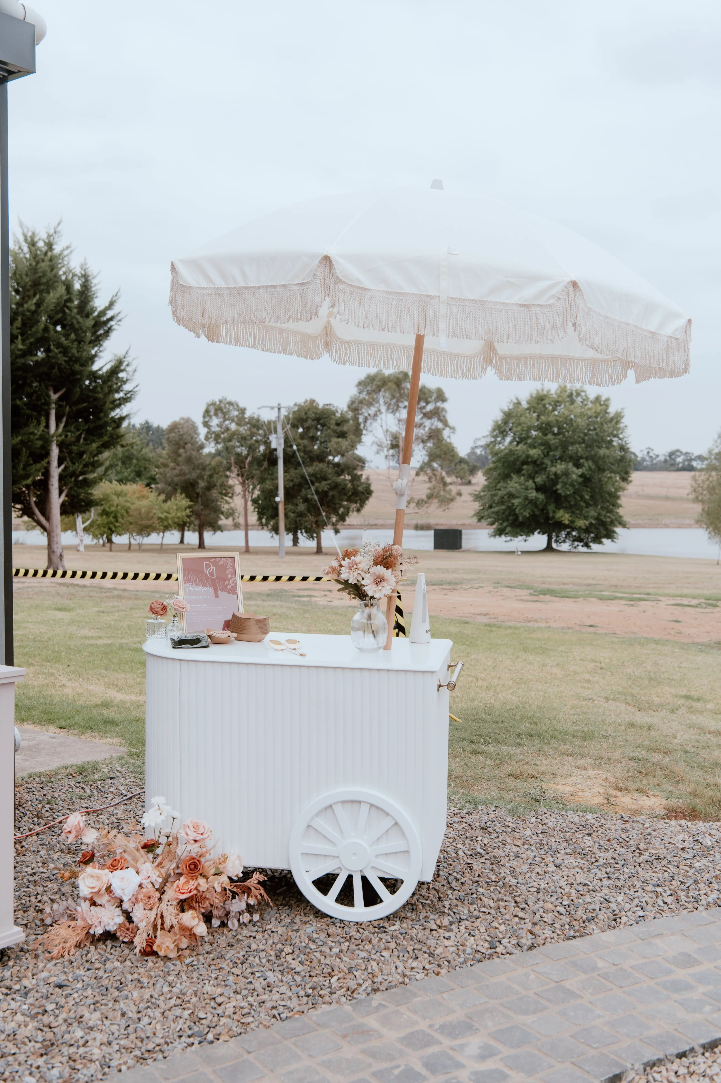 white event cart with umbrella—perfect for weddings, brand activations, and styled displays. Features curved ribbed panelling, brass handle, wheels for easy movement,