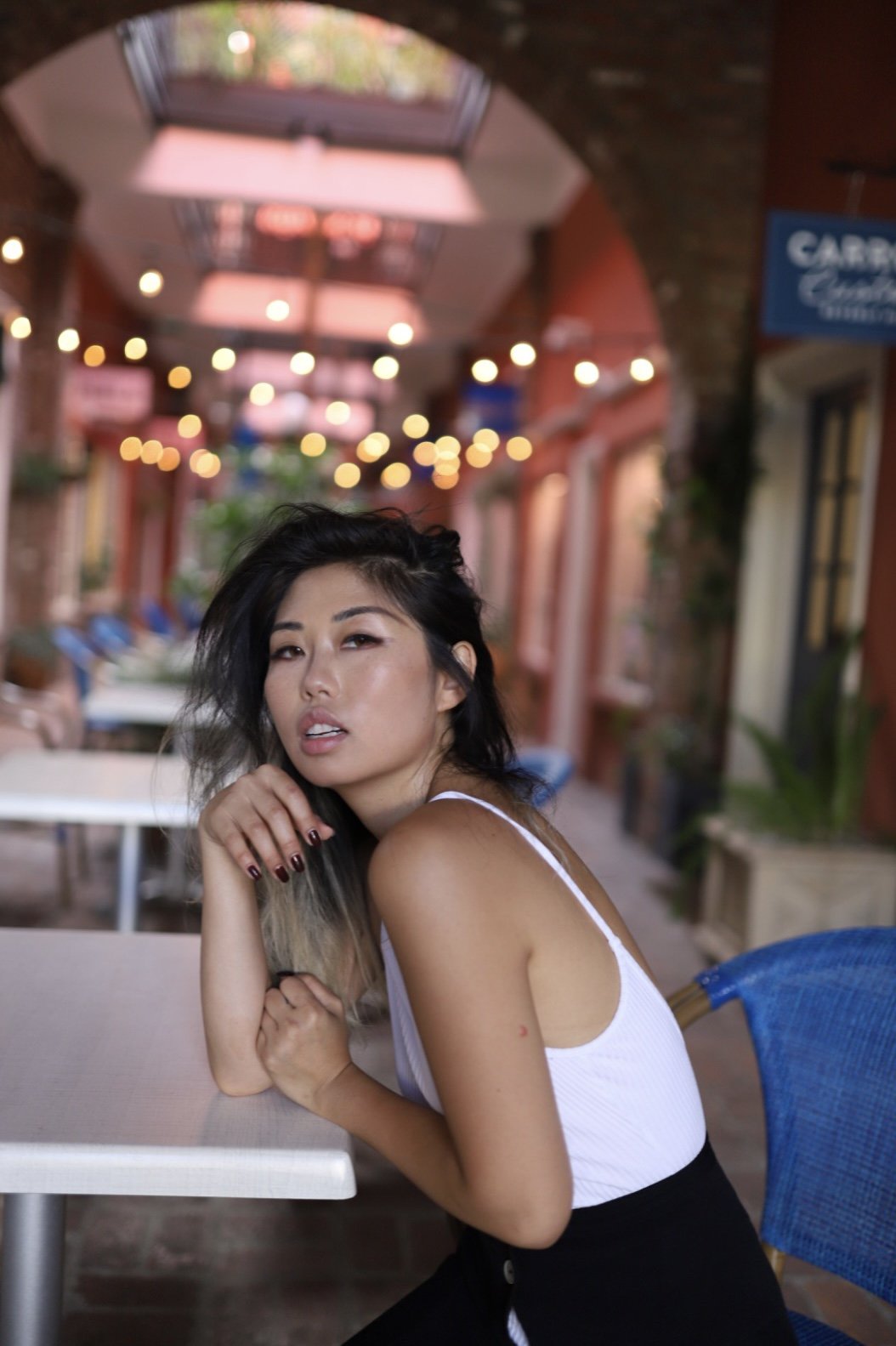 Cindy, wedding and event content creator at Never Tell Moments, seated at outdoor Los Angeles venue