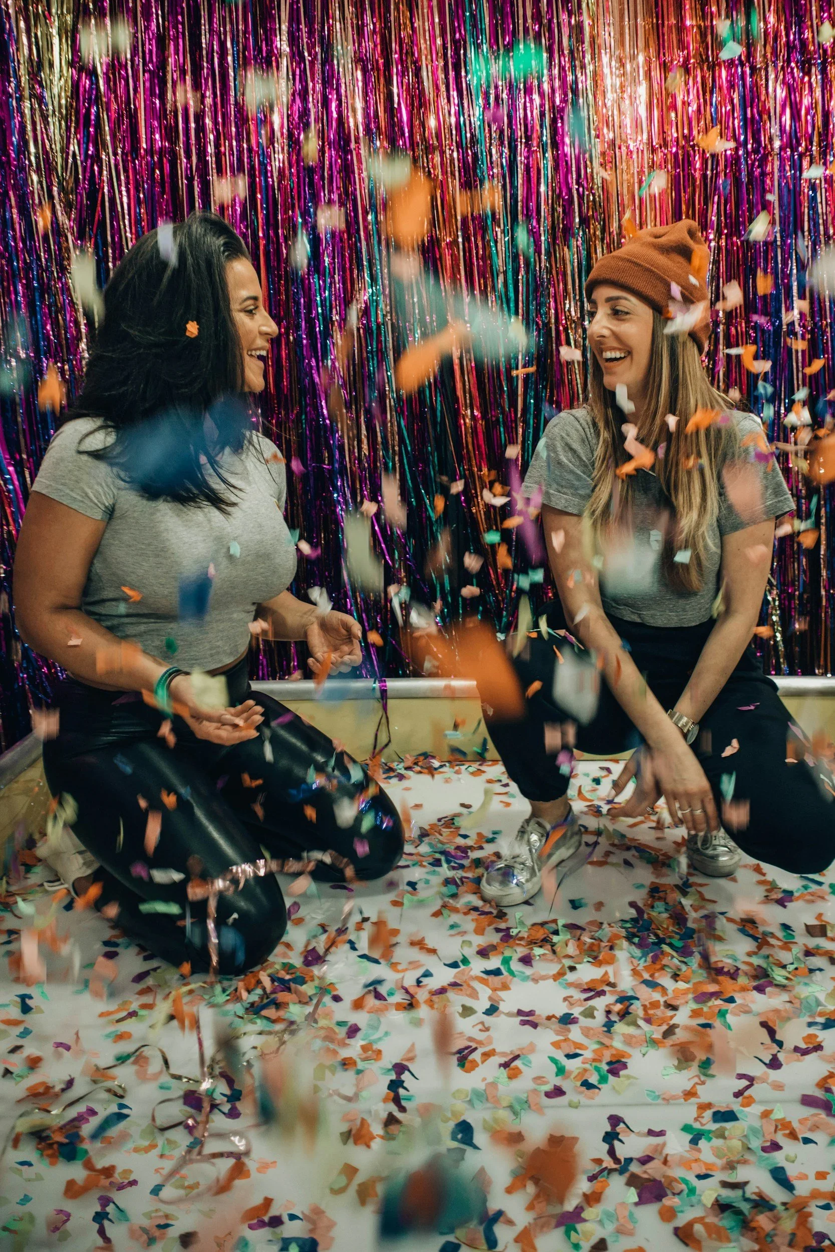 Women celebrating with confetti at a party - event content creation in Los Angeles by Never Tell Moments