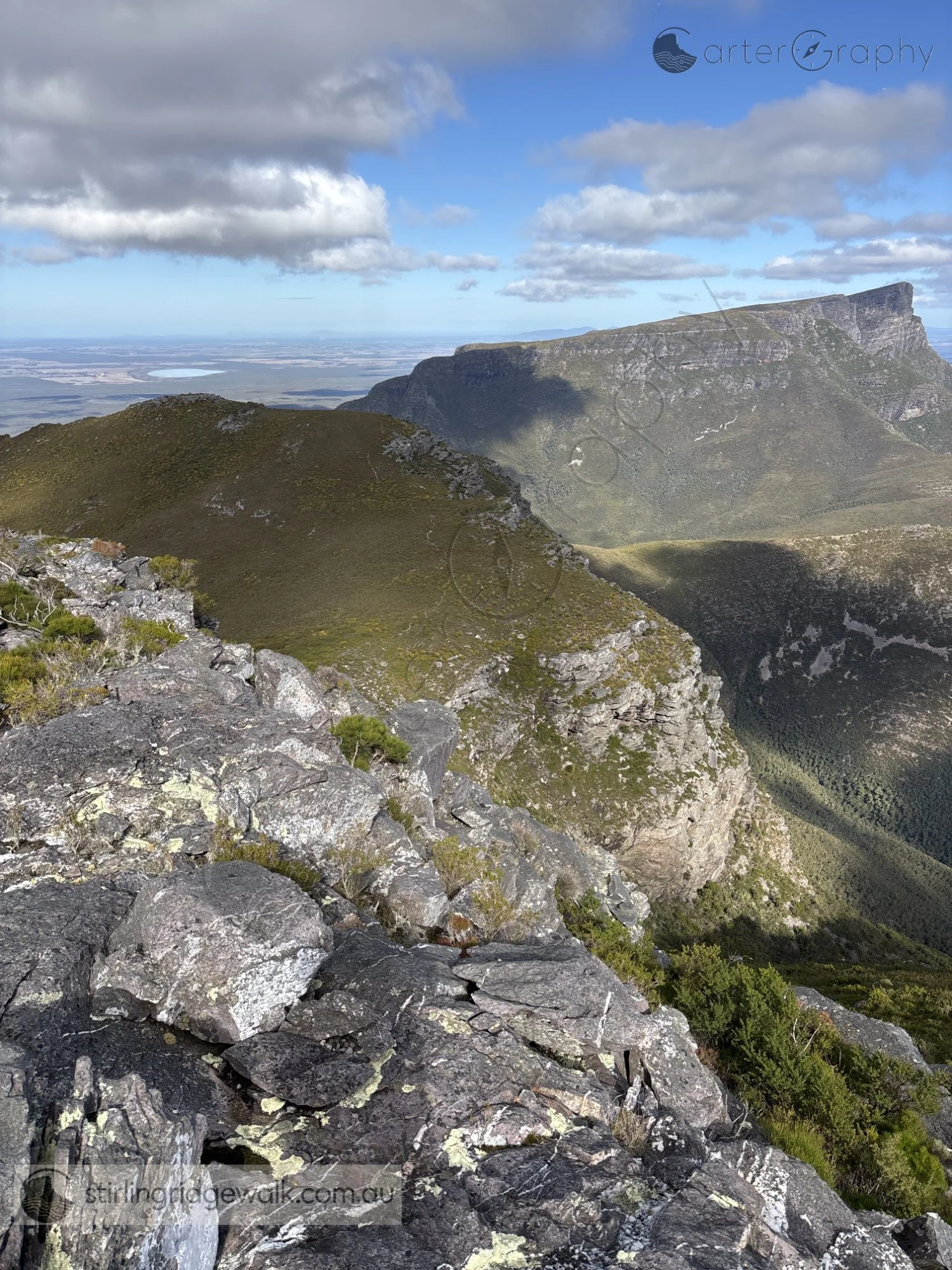 Taken from the summit of Isongerup Main Peak, looking  south west along the ridgeline towards Isongerup South Peak in the foreground, with the broad summit and escarpment of Bluff Knoll dominating the background.