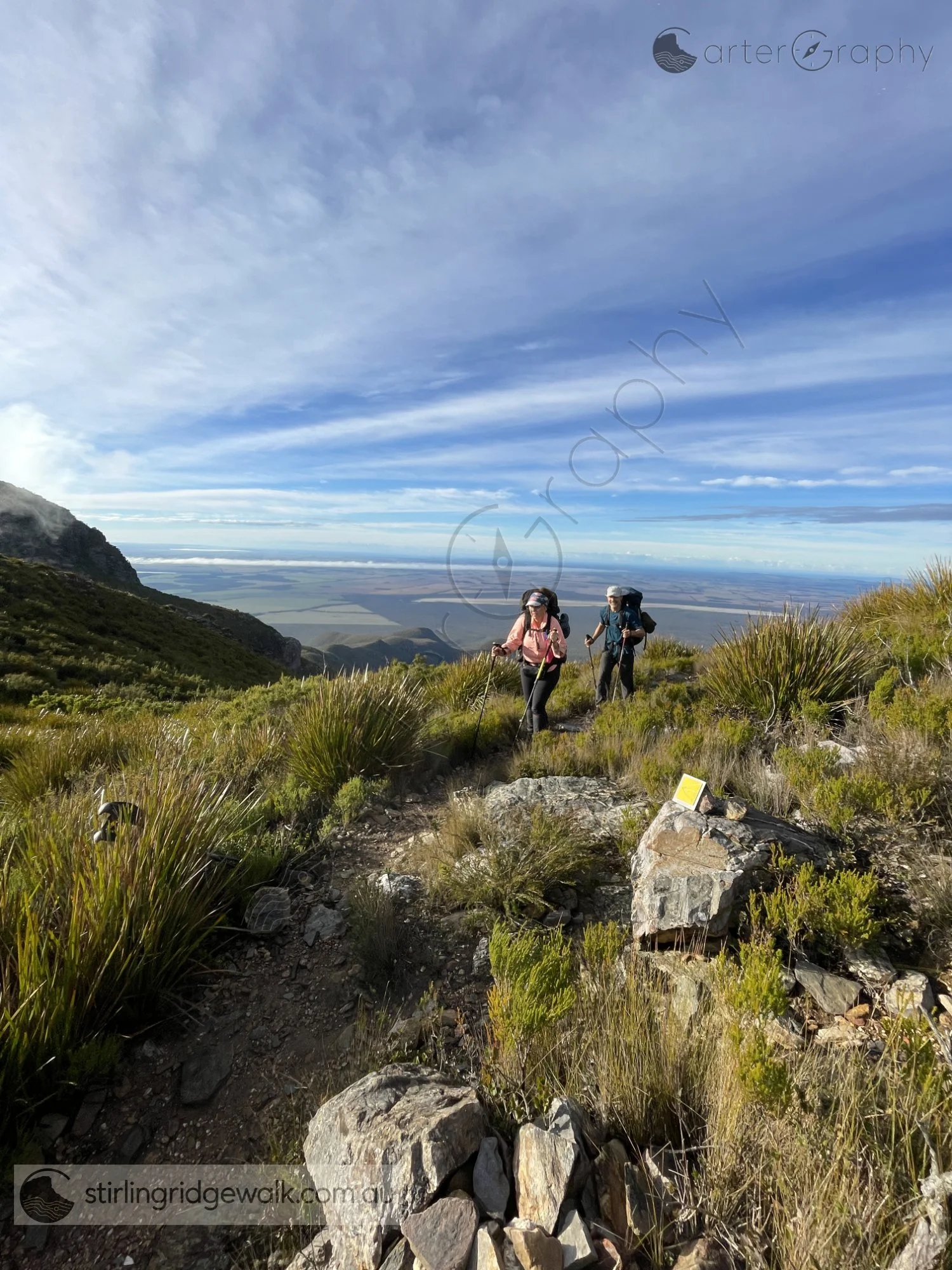 Walkers approaching from Pyungoorup Cave towards the yellow ground marker just west of the ascent to Pyungoorup Peak summit.
