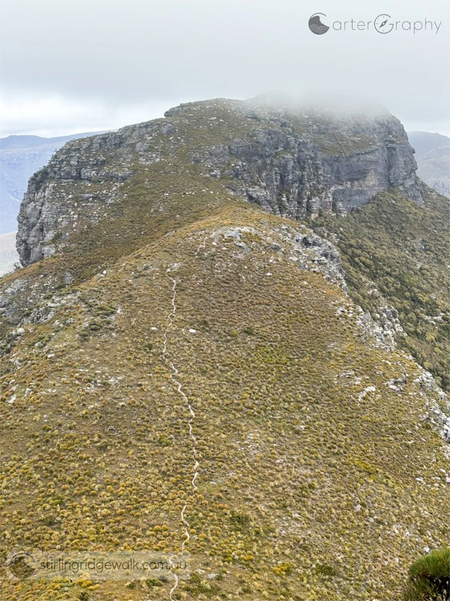 Looking west from the summit of Ellen Peak towards Pyungoorup Peak. The Stirling Ridge Walk track can be clearly seen crossing the small saddle towards the yellow ground marker below the imposing northern face of Pyungoorup Peak. From the marker, the