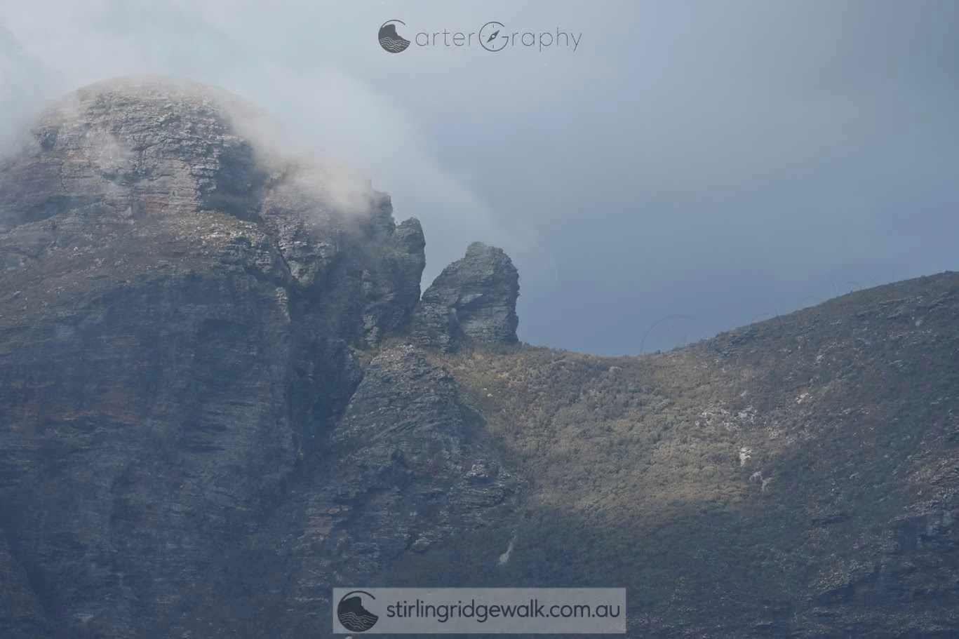 Zoomed in from the North Boundary Track showing the western face of Pyungoorup Peak, with Pyungoorup Pinnacle clearly visible as a detached rock formation standing apart from the main face of the peak.