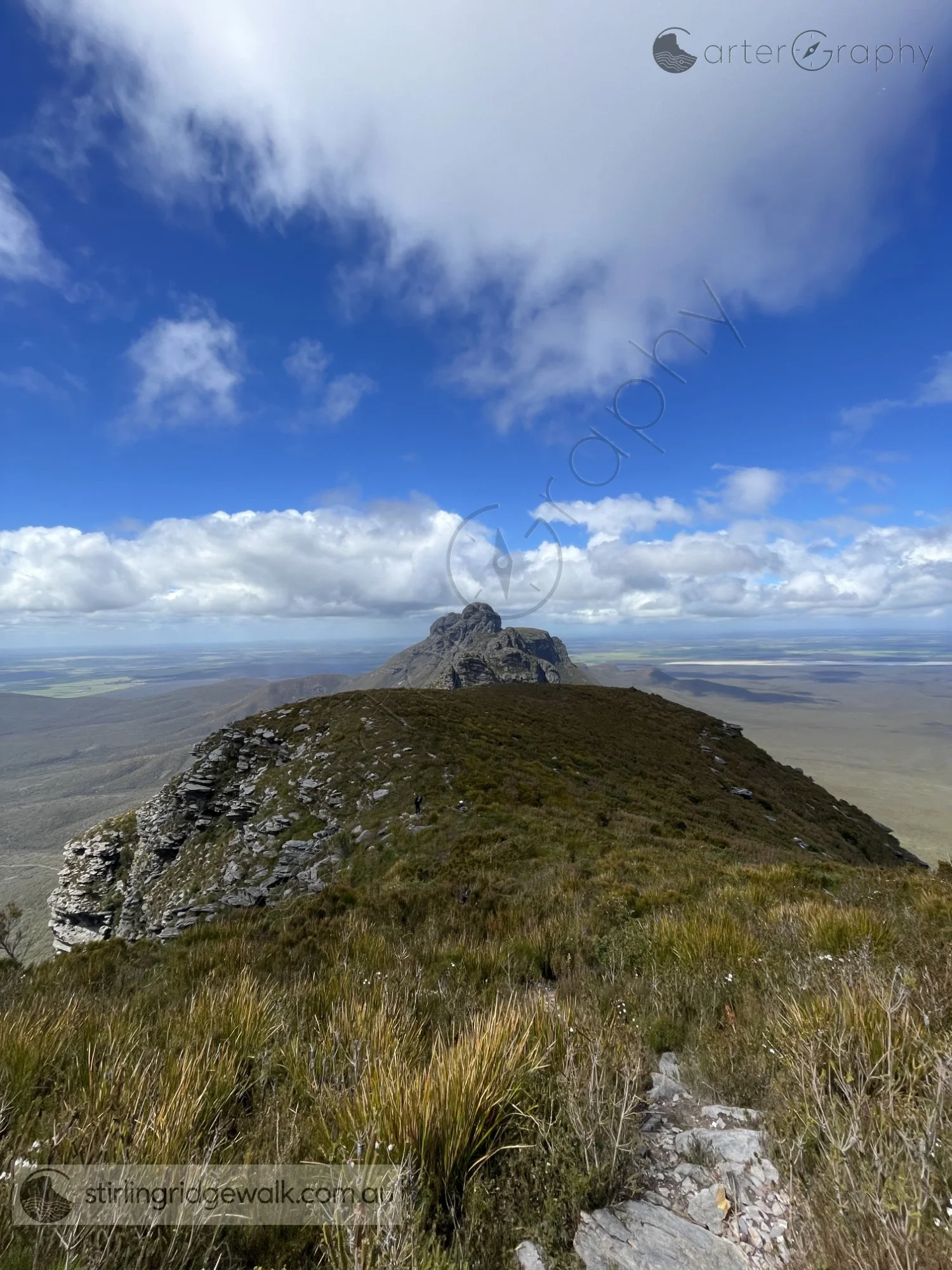 Taken from the summit of Isongerup North Peak, looking directly east along the ridgeline towards the rugged Arrow terrain, with the broad plains stretching away on either side.