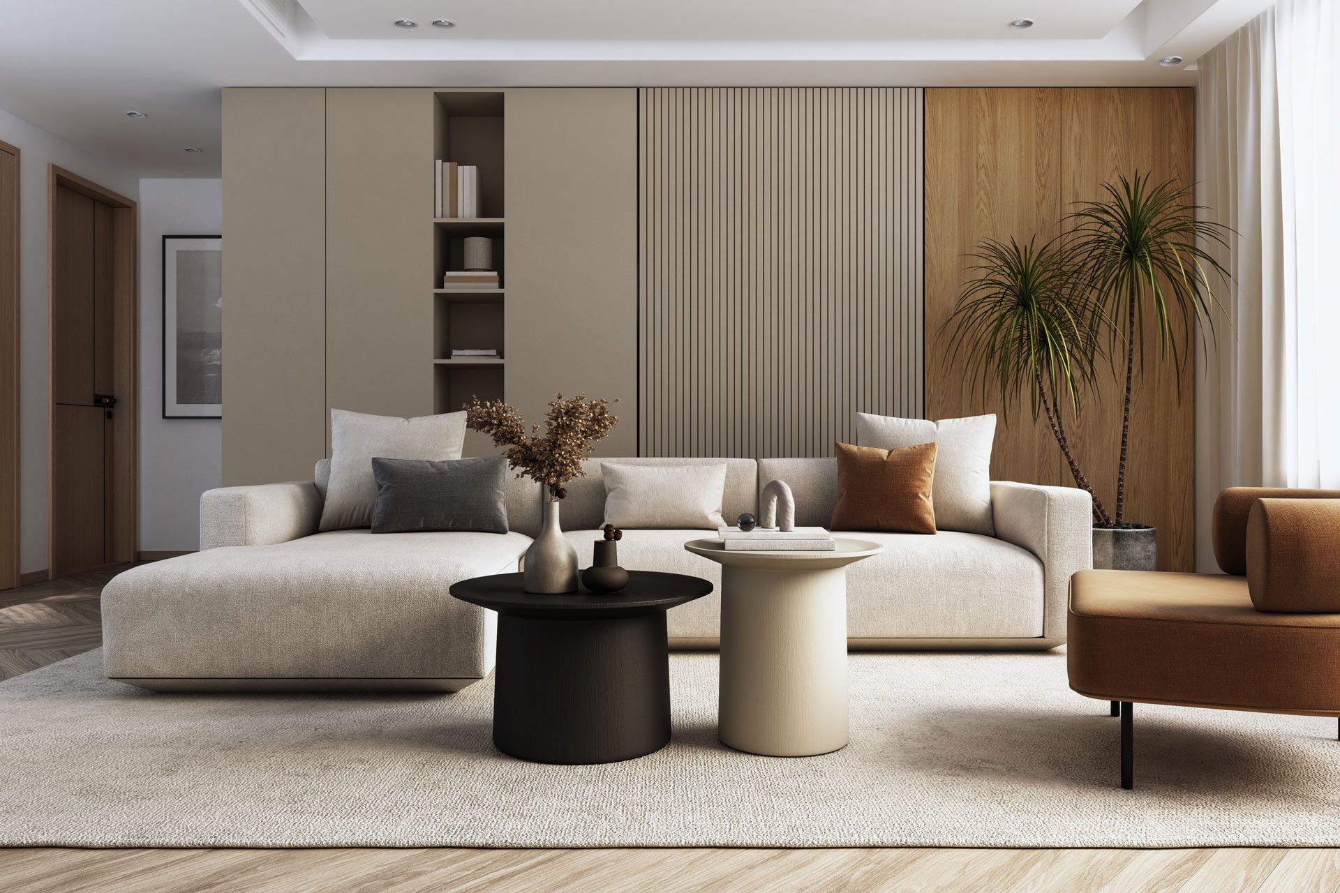 Living room with beige sectional sofa, brown and gray throw pillows, black and white round coffee tables, decorative vases, beige and wood-paneled walls, green potted plants, and natural light from large windows.