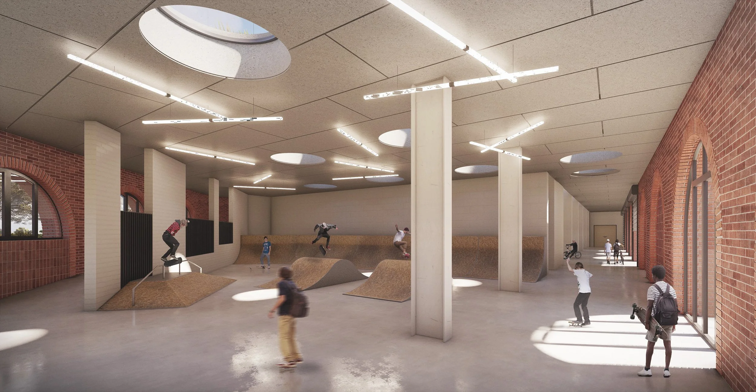 Indoor skatepark with ramps where children and teenagers are skating and skateboarding. Brick walls, large windows, gray ceiling with circular skylights, and modern lighting fixtures.