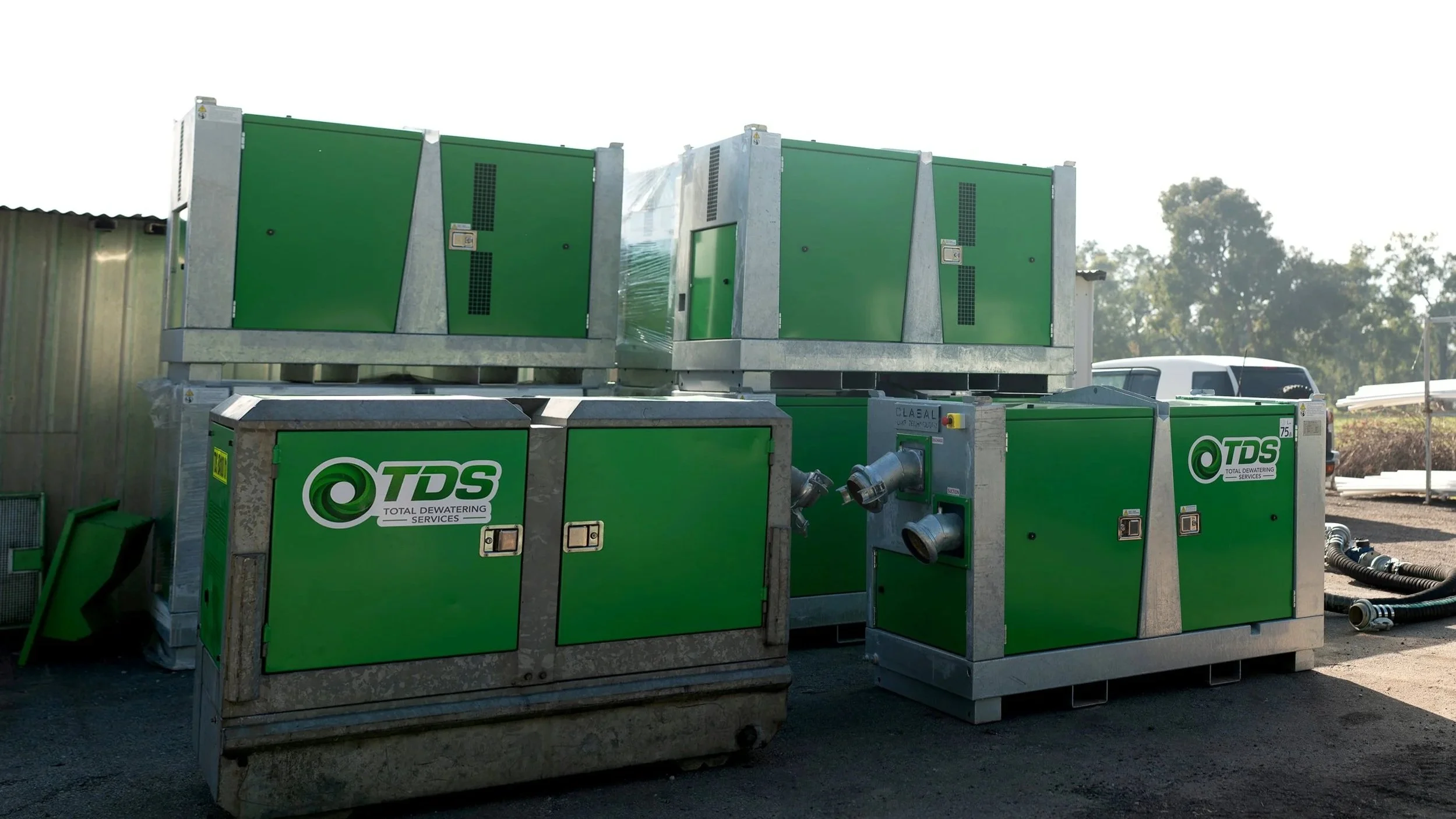Green industrial dewatering machines labeled with TDS logo arranged outdoors.