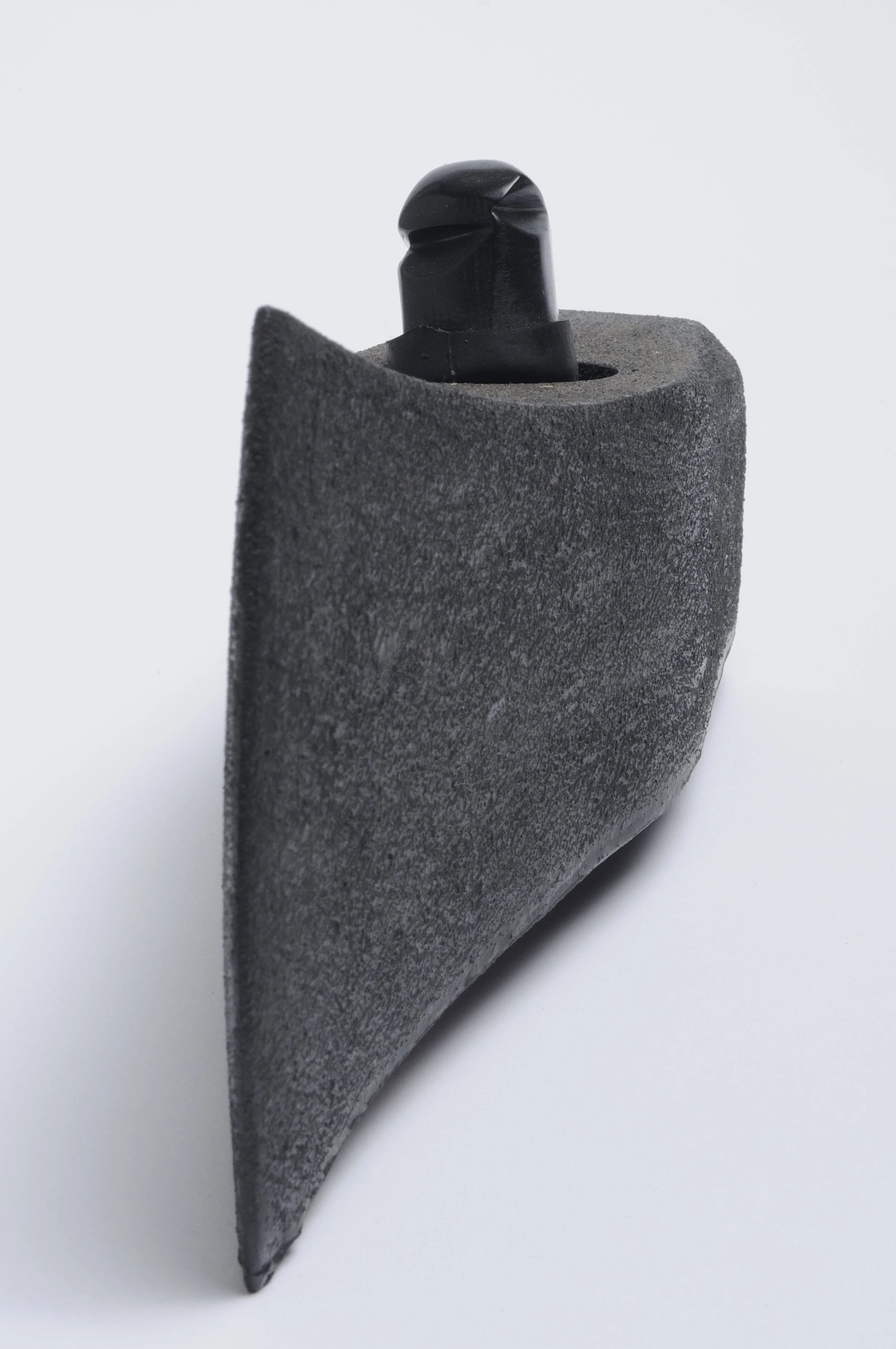 A graphic black and gray object with a textured surface, rounded top, and a protruding black element at the top.