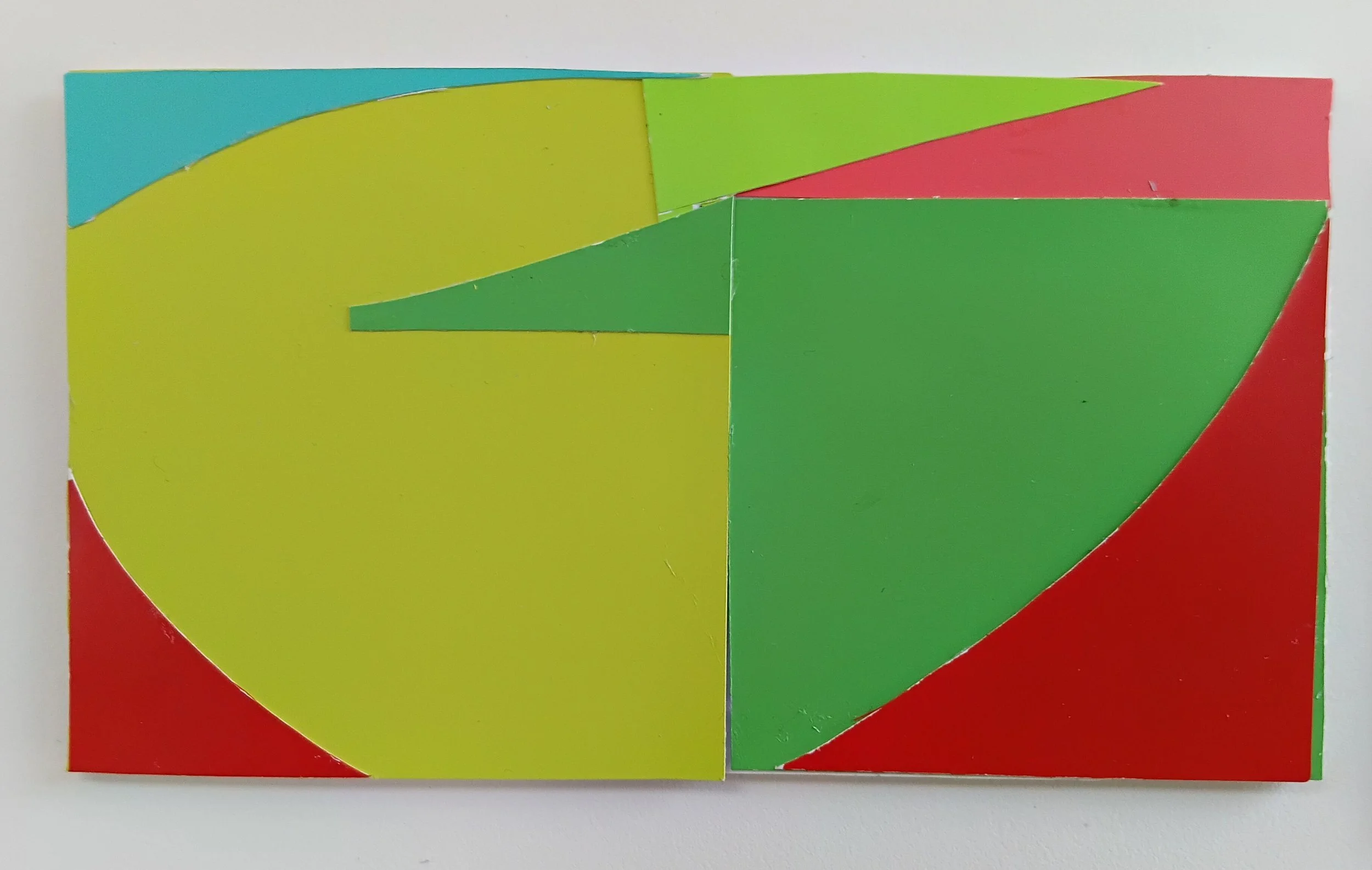 Colorful geometric puzzle with various shapes and colors including yellow, green, red, and blue.