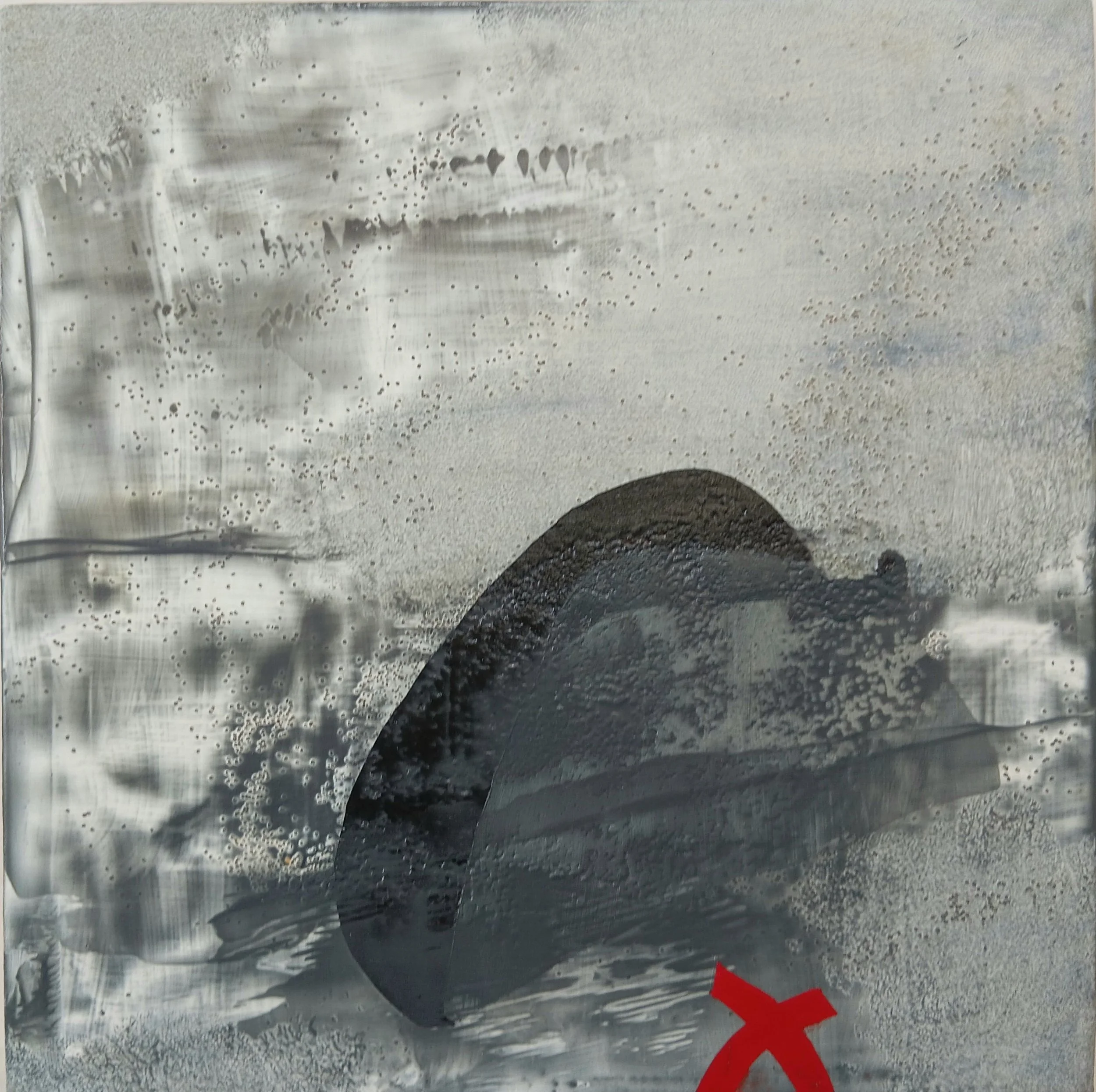 A close-up of a glass with a dark liquid, possibly coffee or tea, with condensation on the outside and condensation spots on the glass surface. A red 'X' mark is near the bottom right corner of the glass.