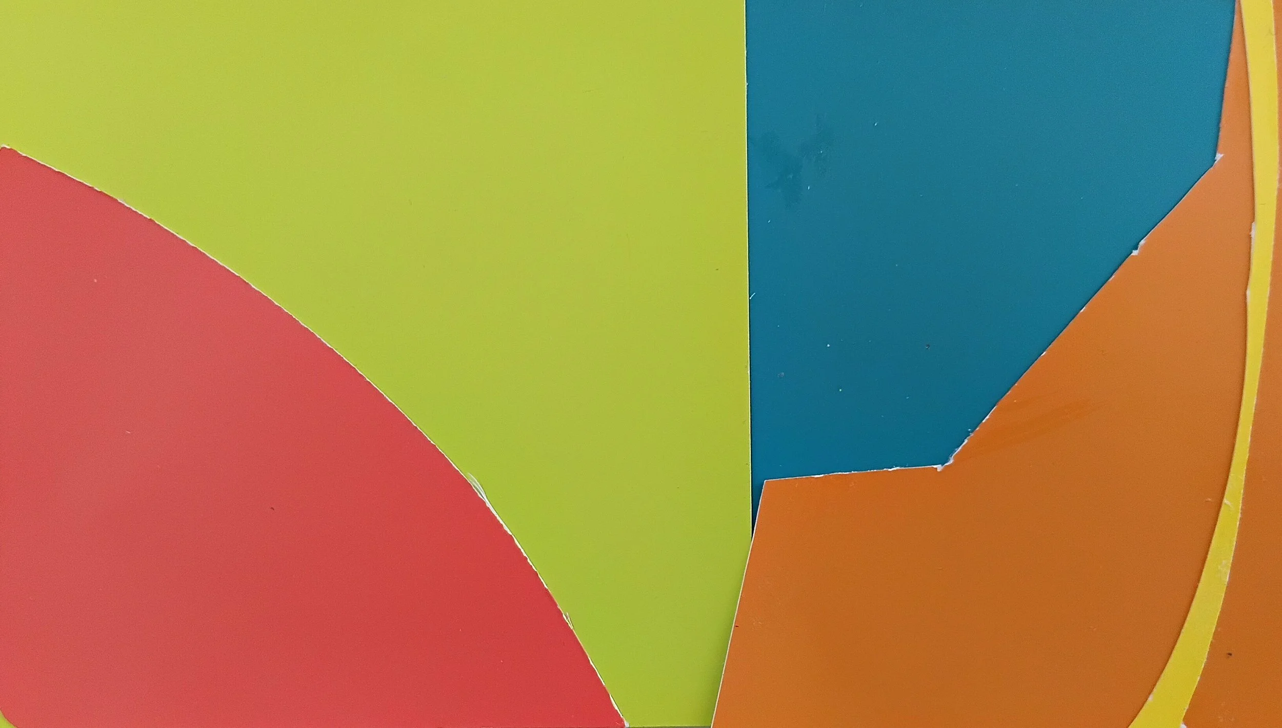 Close-up of colorful paper shapes in red, yellow, green, blue, and orange.
