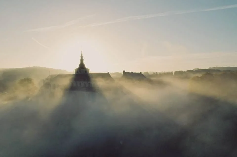 Une vue d'un horizon avec l'abbaye de Floreffe , à travers une brume ou un brouillard, au lever ou coucher du soleil. | QSphotography | Namur