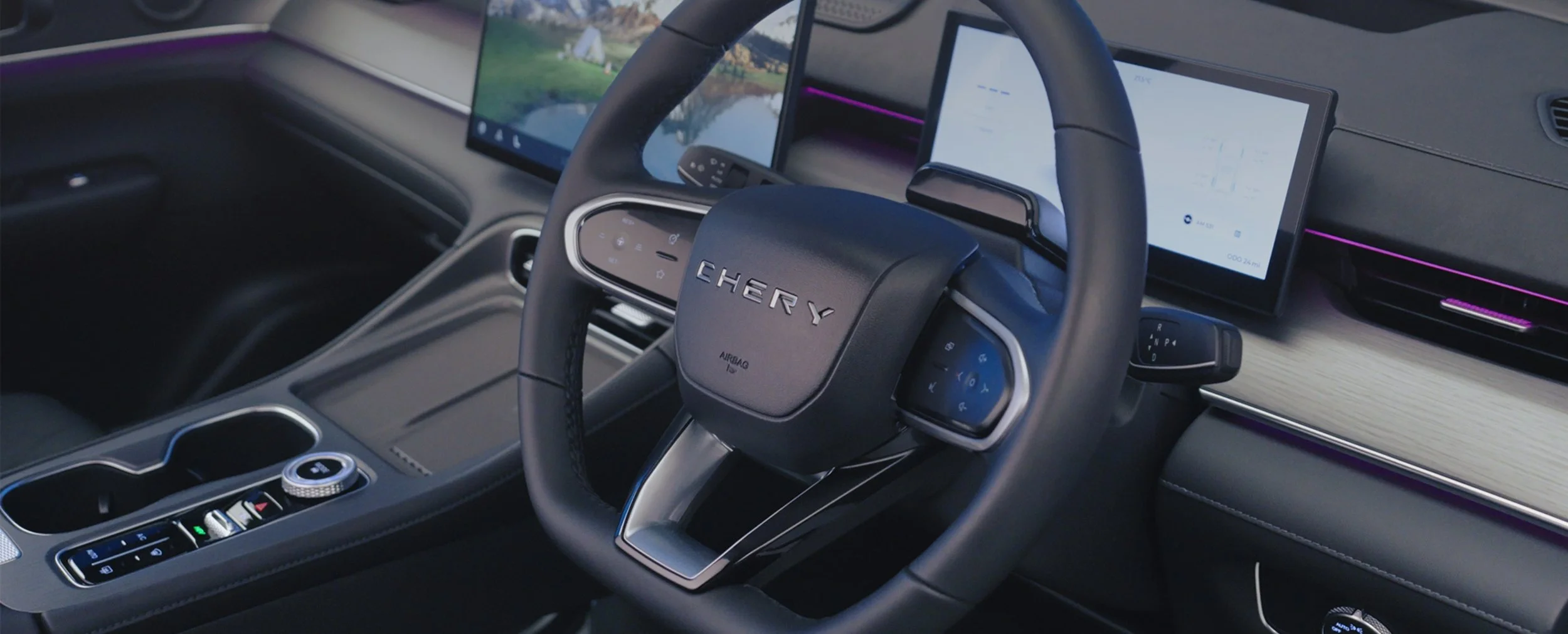 Interior of a modern vehicle, showcasing a steering wheel with the brand name 'Chery', digital displays, and a sleek dashboard design with controls and ambient lighting.