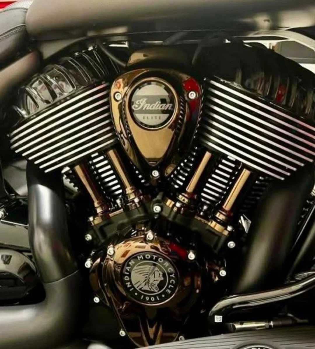 A close-up view of a black Indian motorcycle engine with chrome accents and the Indian Motorcycle logo.