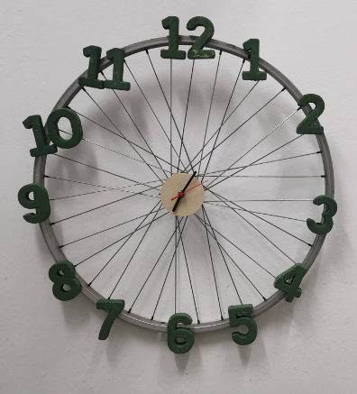Repurposed bicycle wheel rim transformed into a functional classroom clock.
