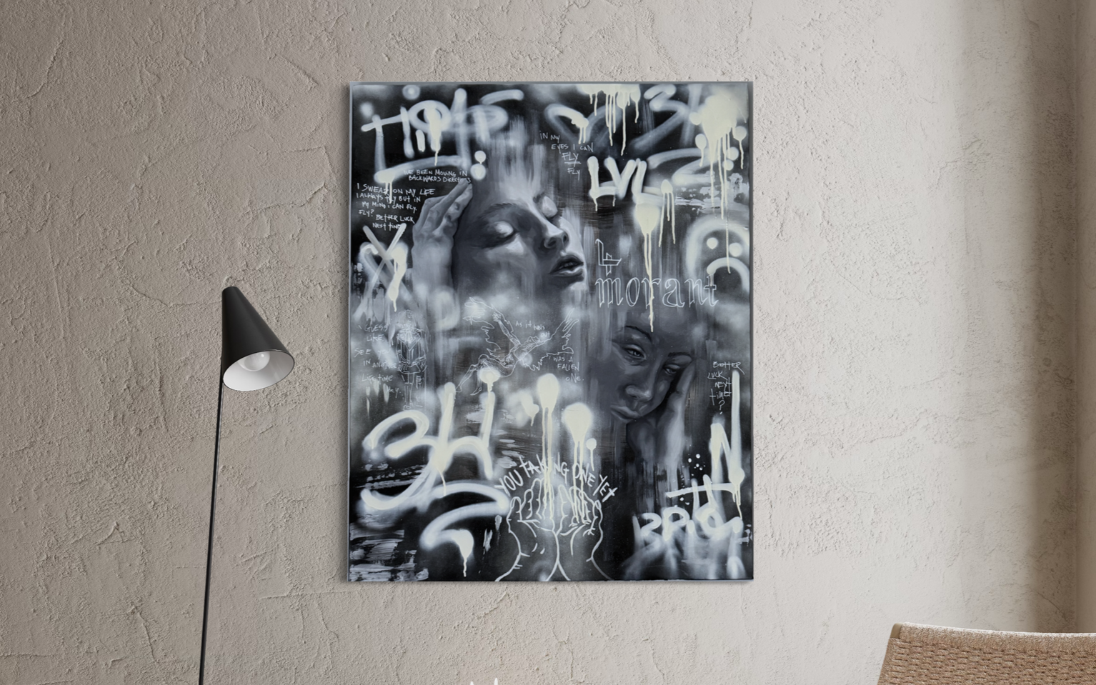 Graffiti-style black and white artwork featuring two female faces, various words like 'morbant', and abstract designs on a wall.
