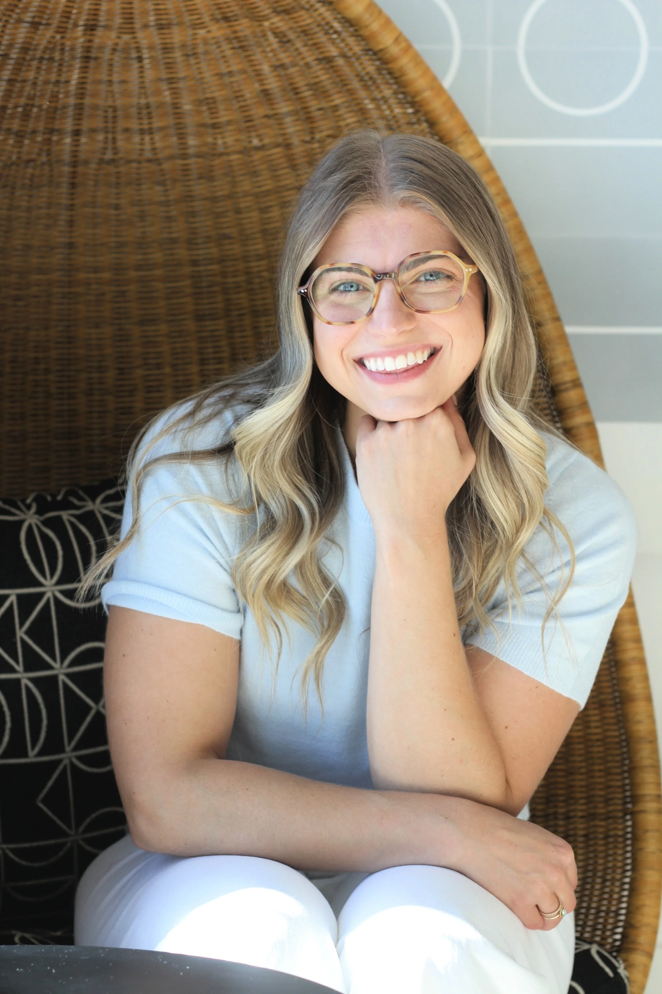smiling therapist sitting in chair with thinking, intelligent pose