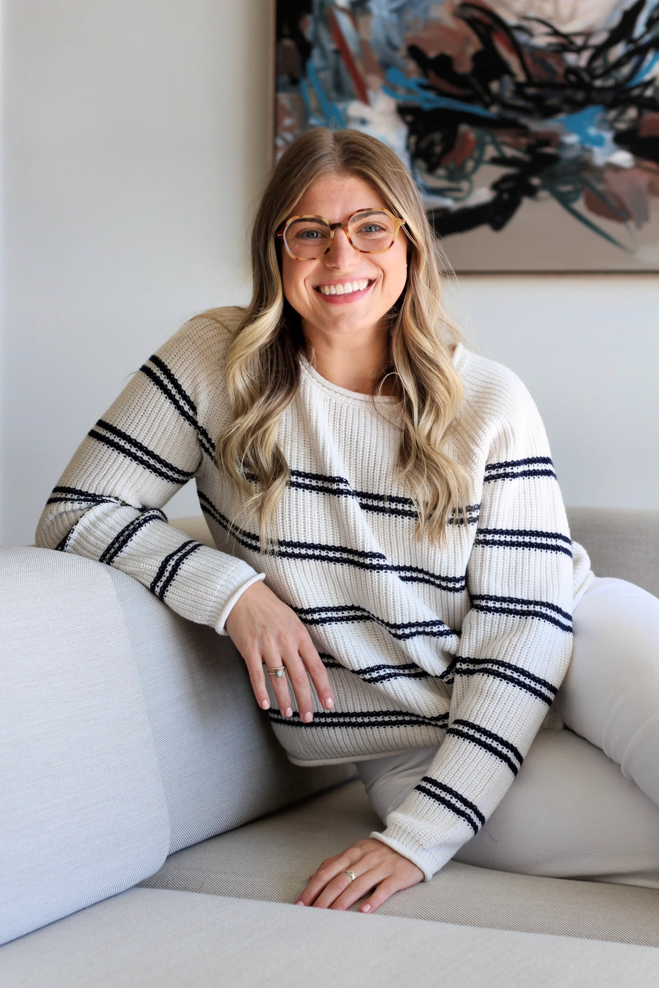 therapist in sweater sitting with compassionate and open body language