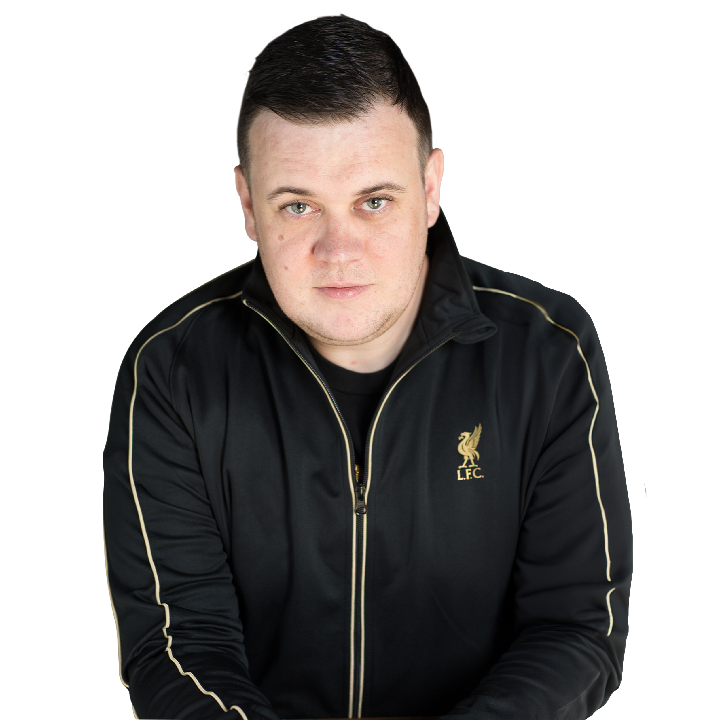 A young man with short dark hair, wearing a black sports jacket with gold stripes and an embroidered Liverpool Football Club logo, looking directly at the camera.