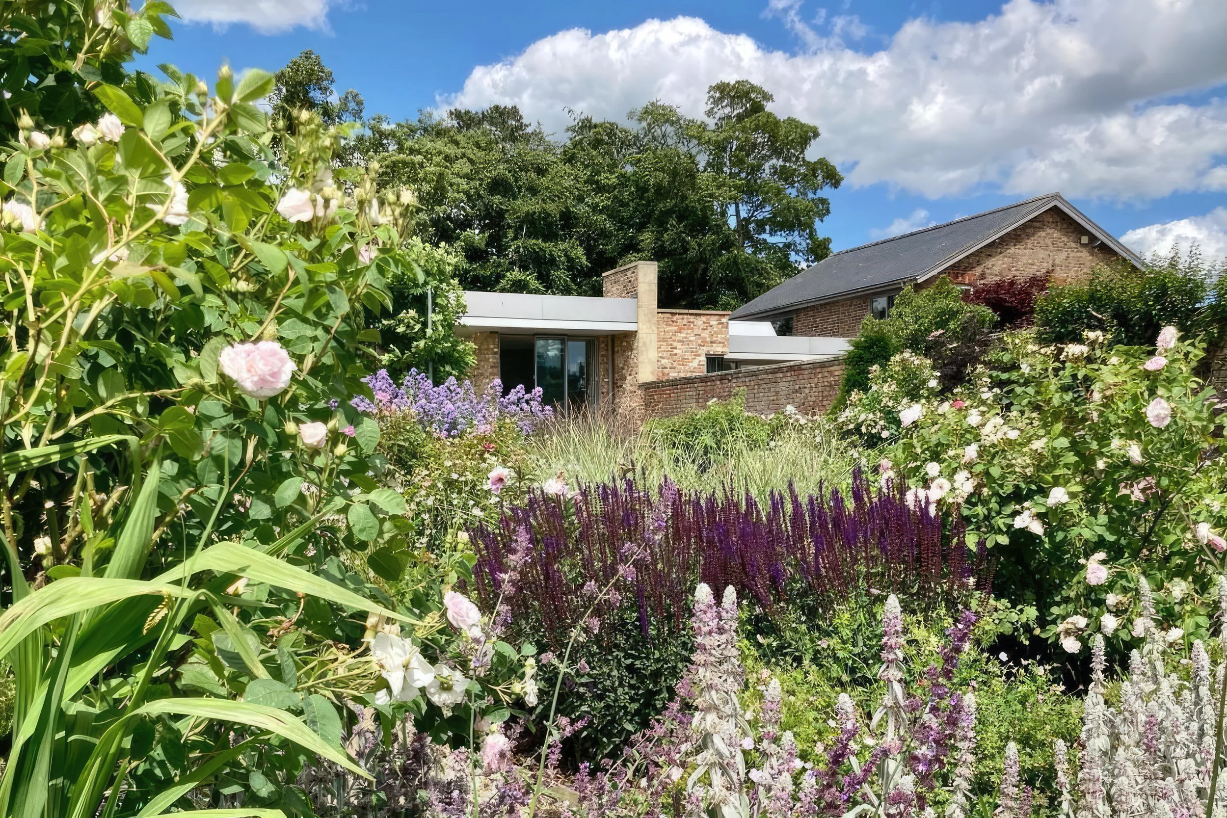 Cunelands House — new build and existing cottages unified, garden view