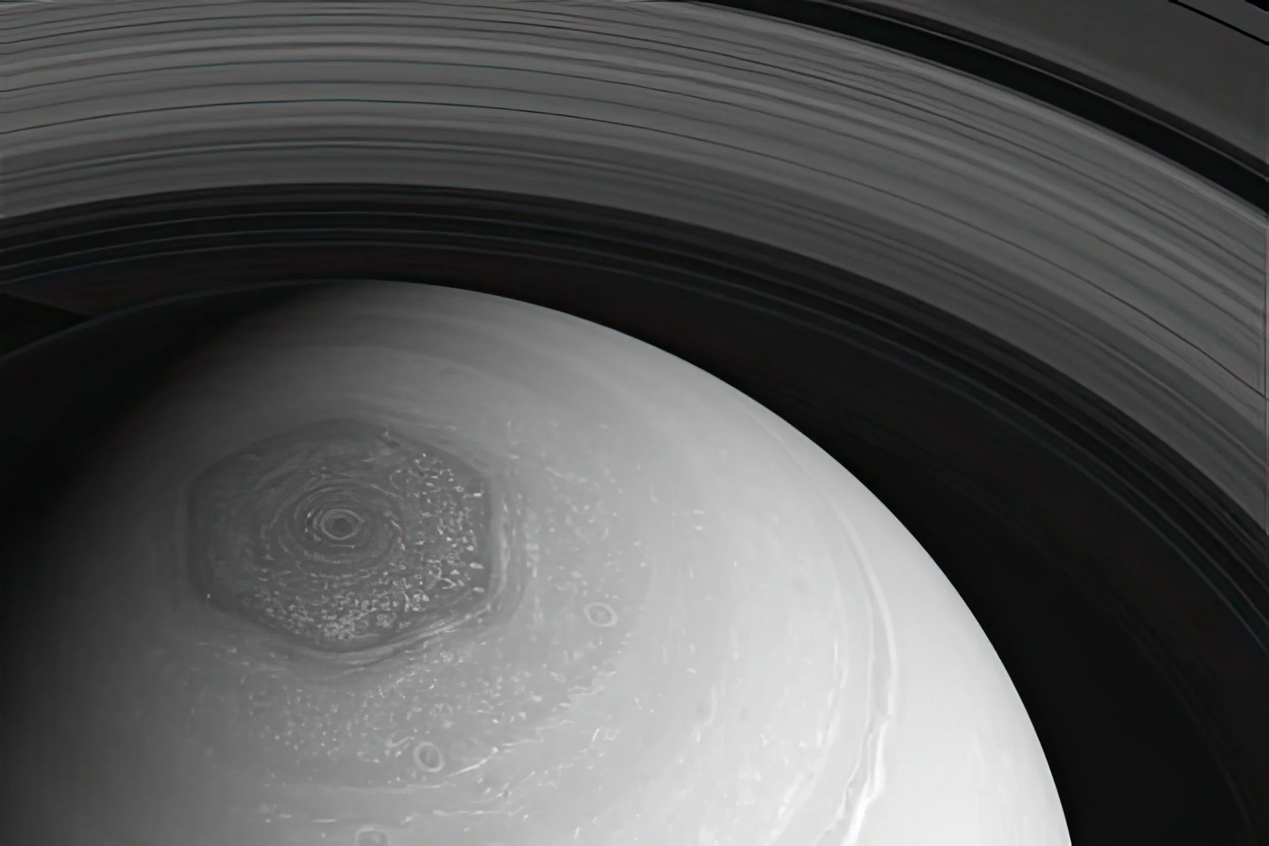 Close-up of Saturn's rings and its moon or planet surface.