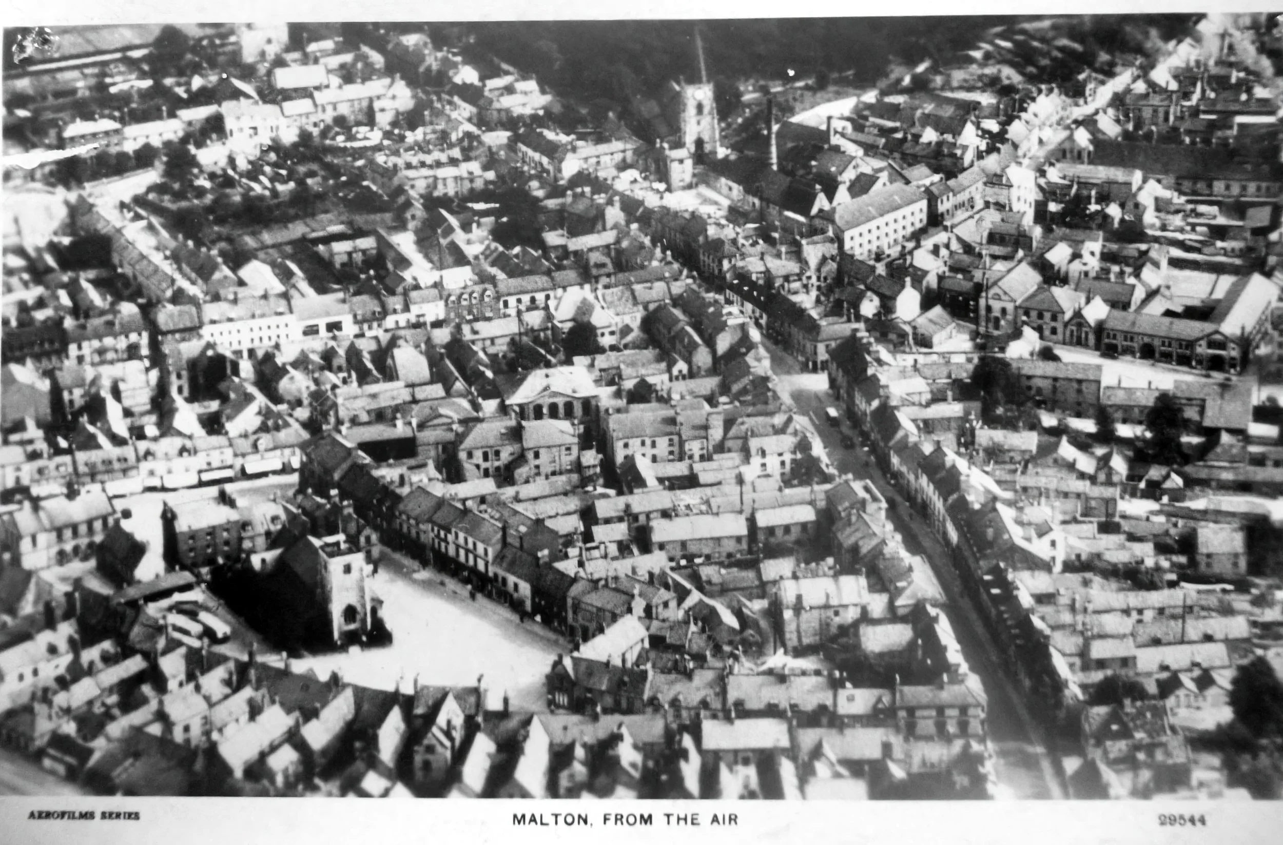 Black and white aerial photograph of a town with many tightly packed buildings and narrow streets, labeled "Malton, from the air".