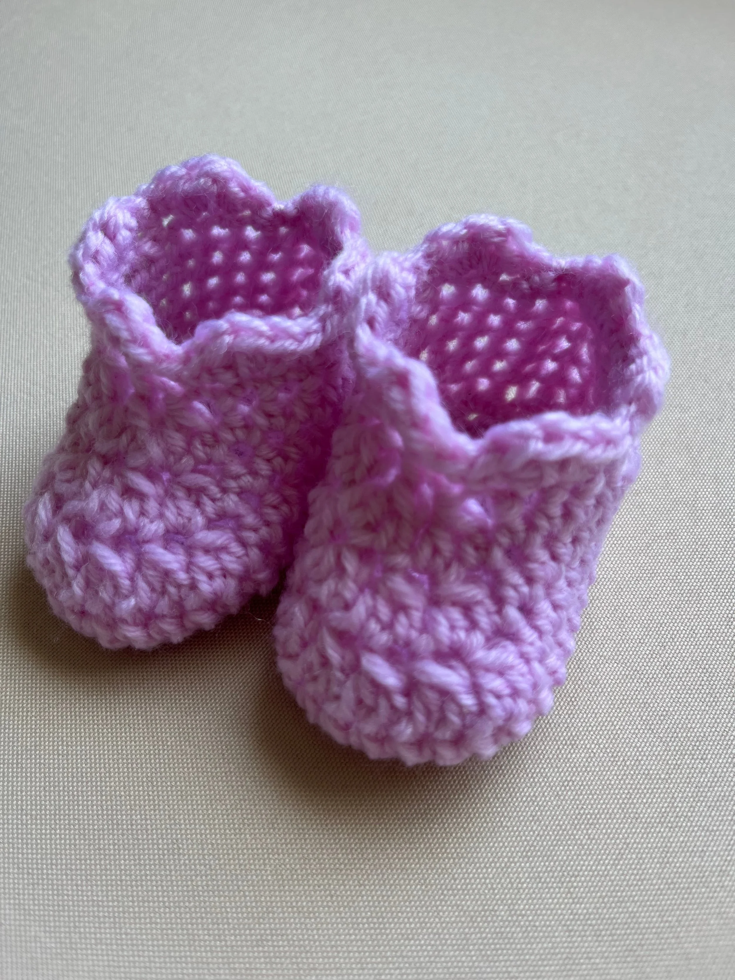Handmade baby booties in pink soft acrylic yarn by Tidestitch.jpg