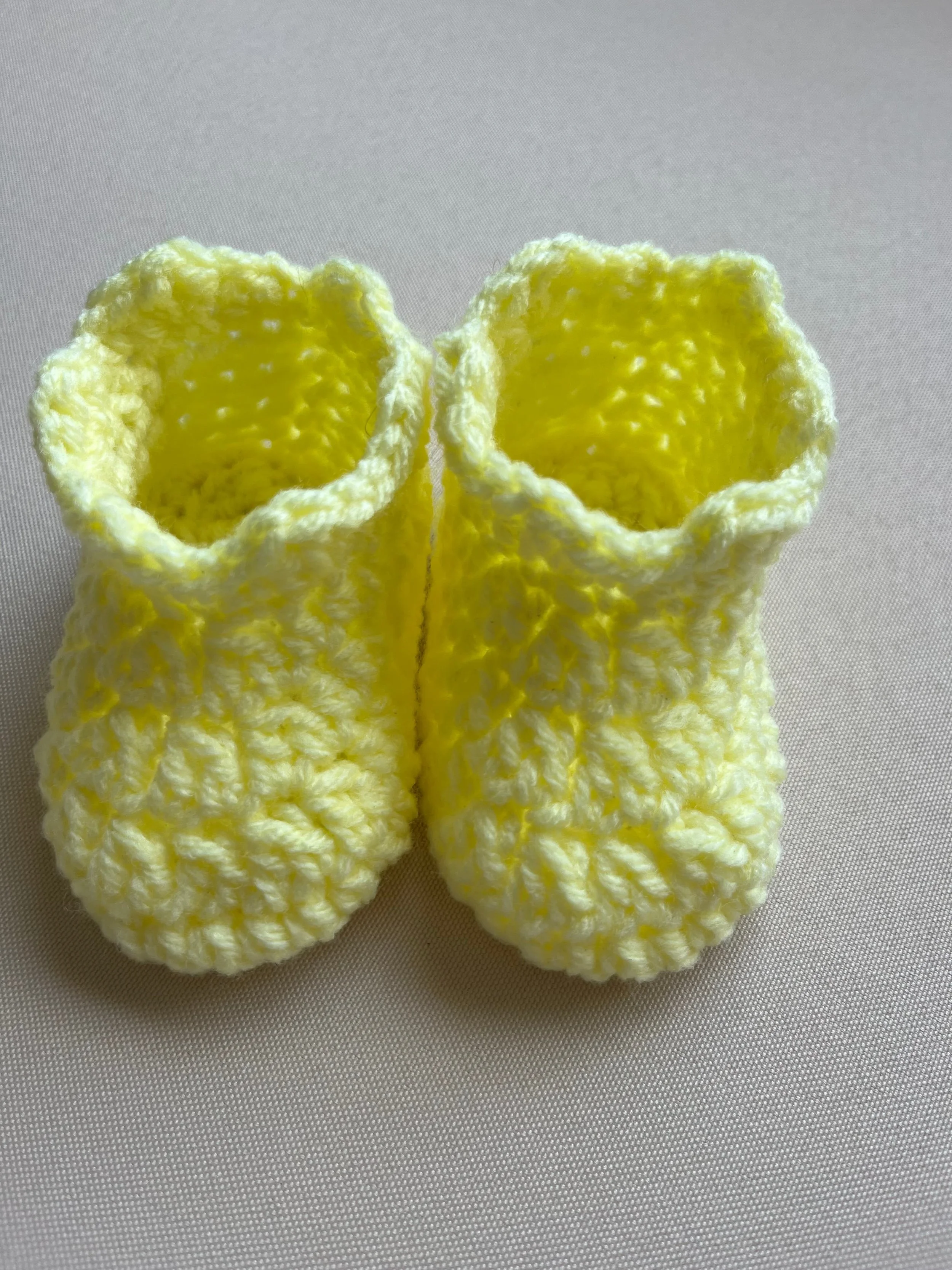 Handmade baby booties in yellow soft acrylic yarn by Tidestitch.jpg