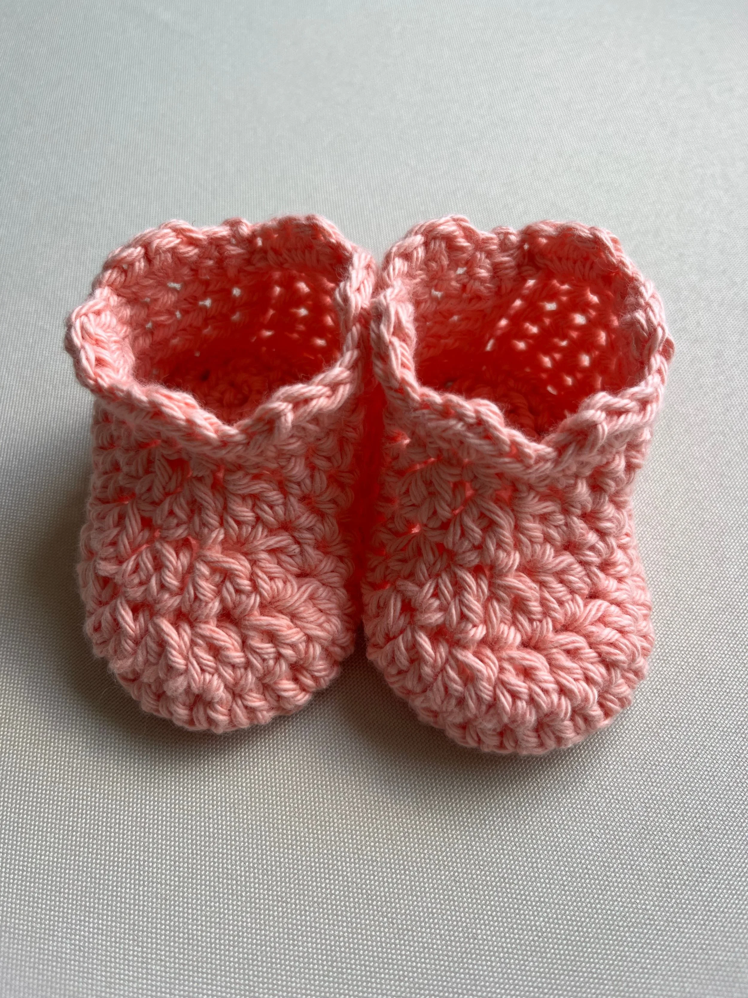 Handmade baby booties in peach soft cotton yarn by Tidestitch.jpg