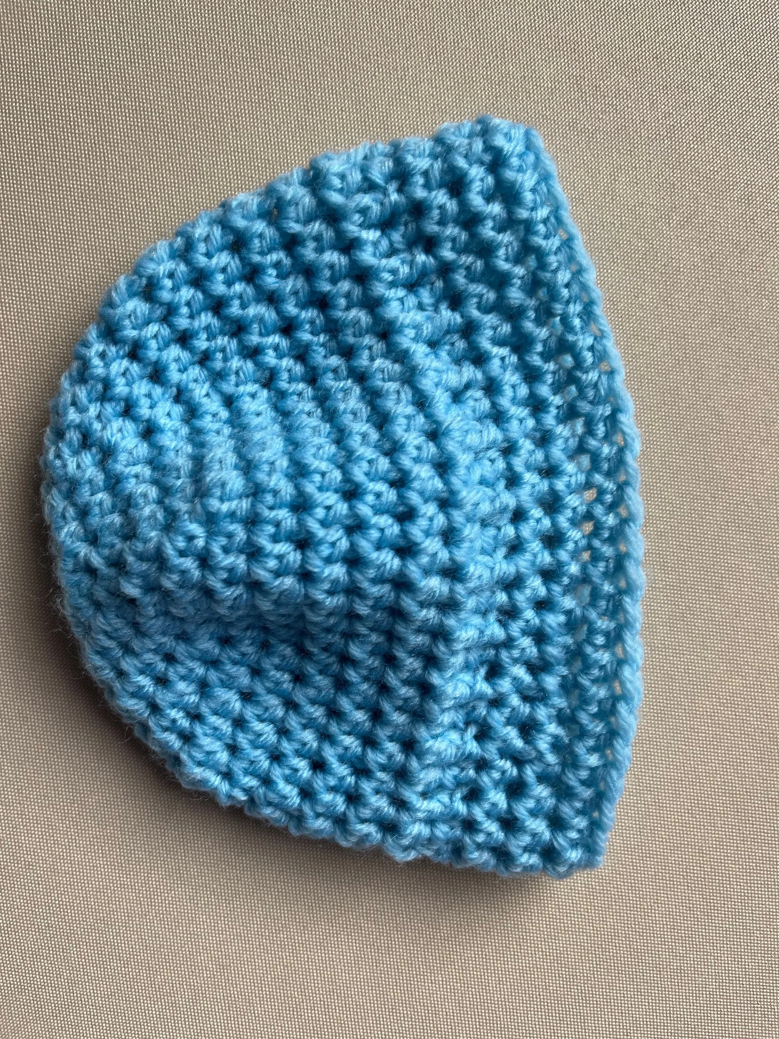 Handmade baby beanie in light blue soft acrylic blend yarn by Tidestitch angle 2..jpg