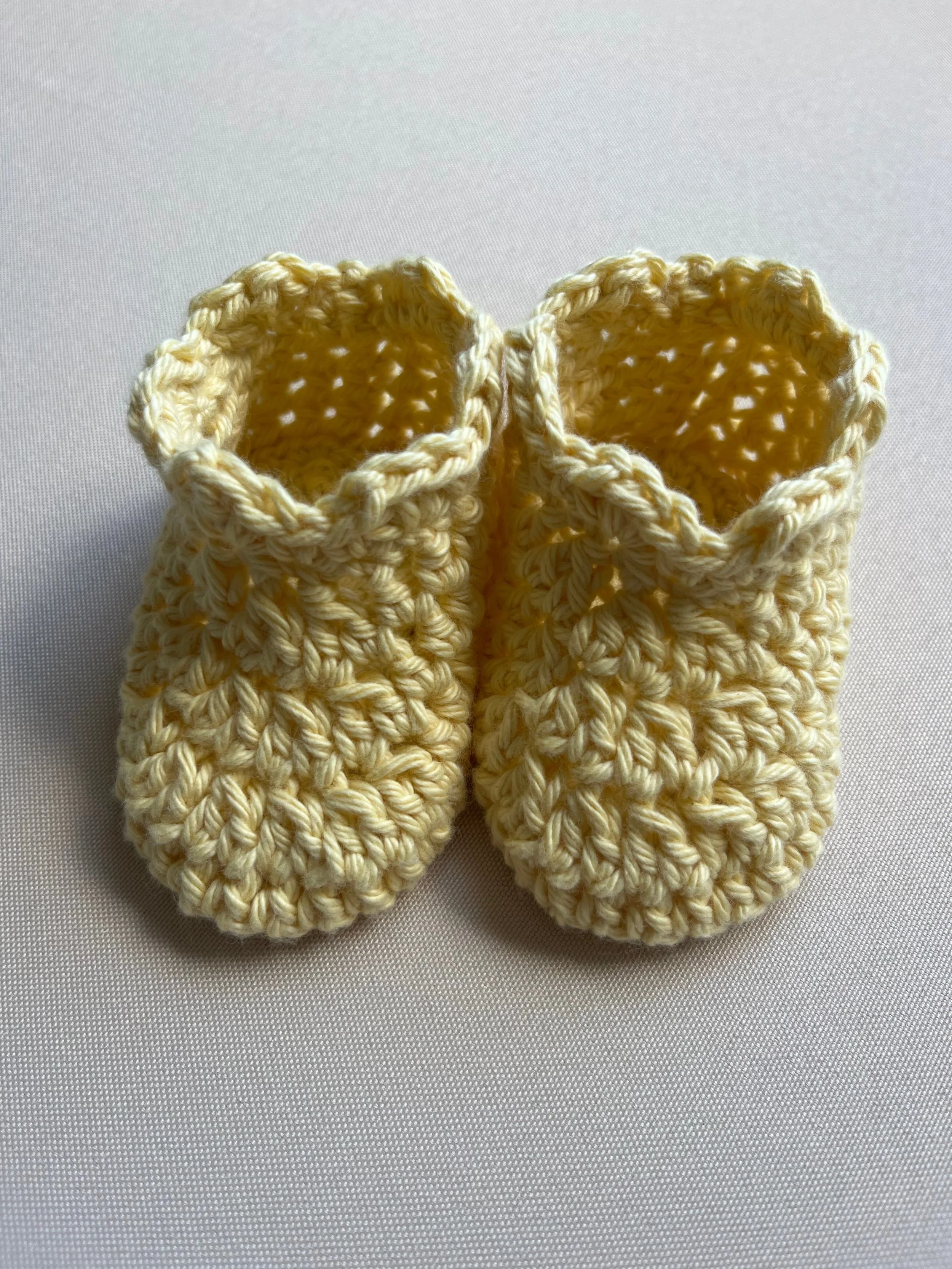 Handmade baby booties in yellow soft cotton yarn by Tidestitch.jpg