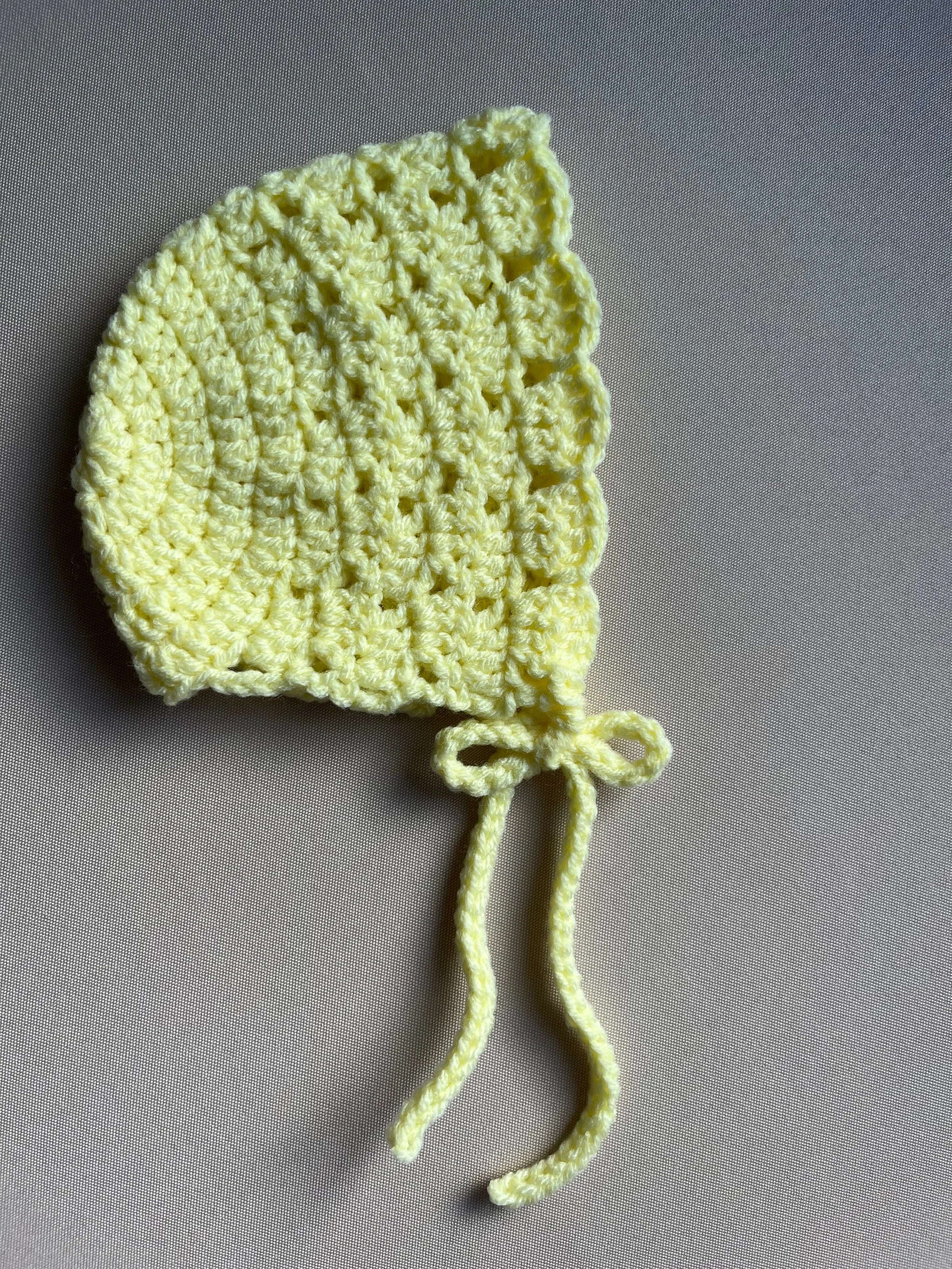 Handmade baby bonnet in yellow soft acrylic blend yarn by Tidestitch..jpg
