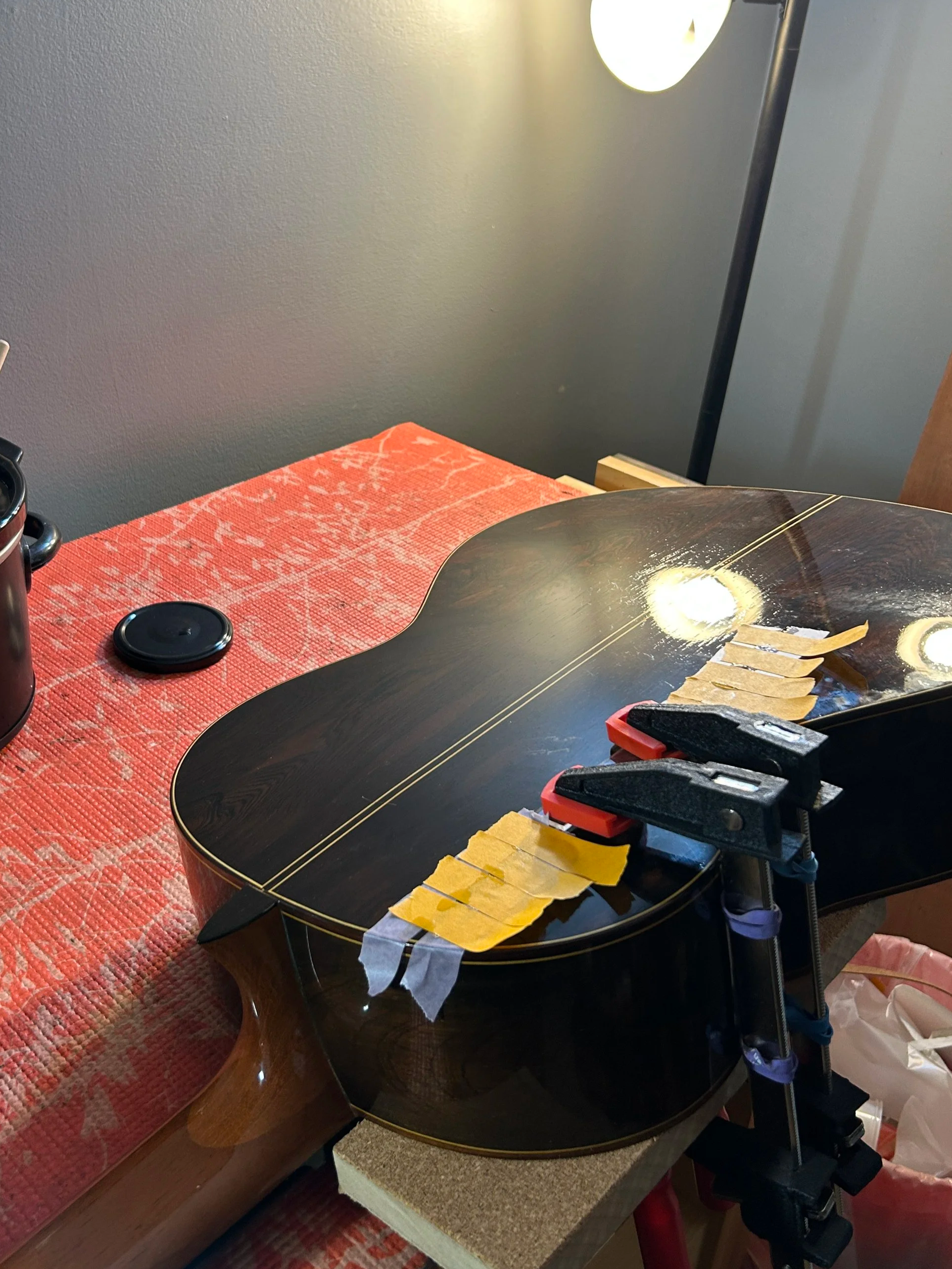 Close-up of a guitar being fixed due to a big back crack.