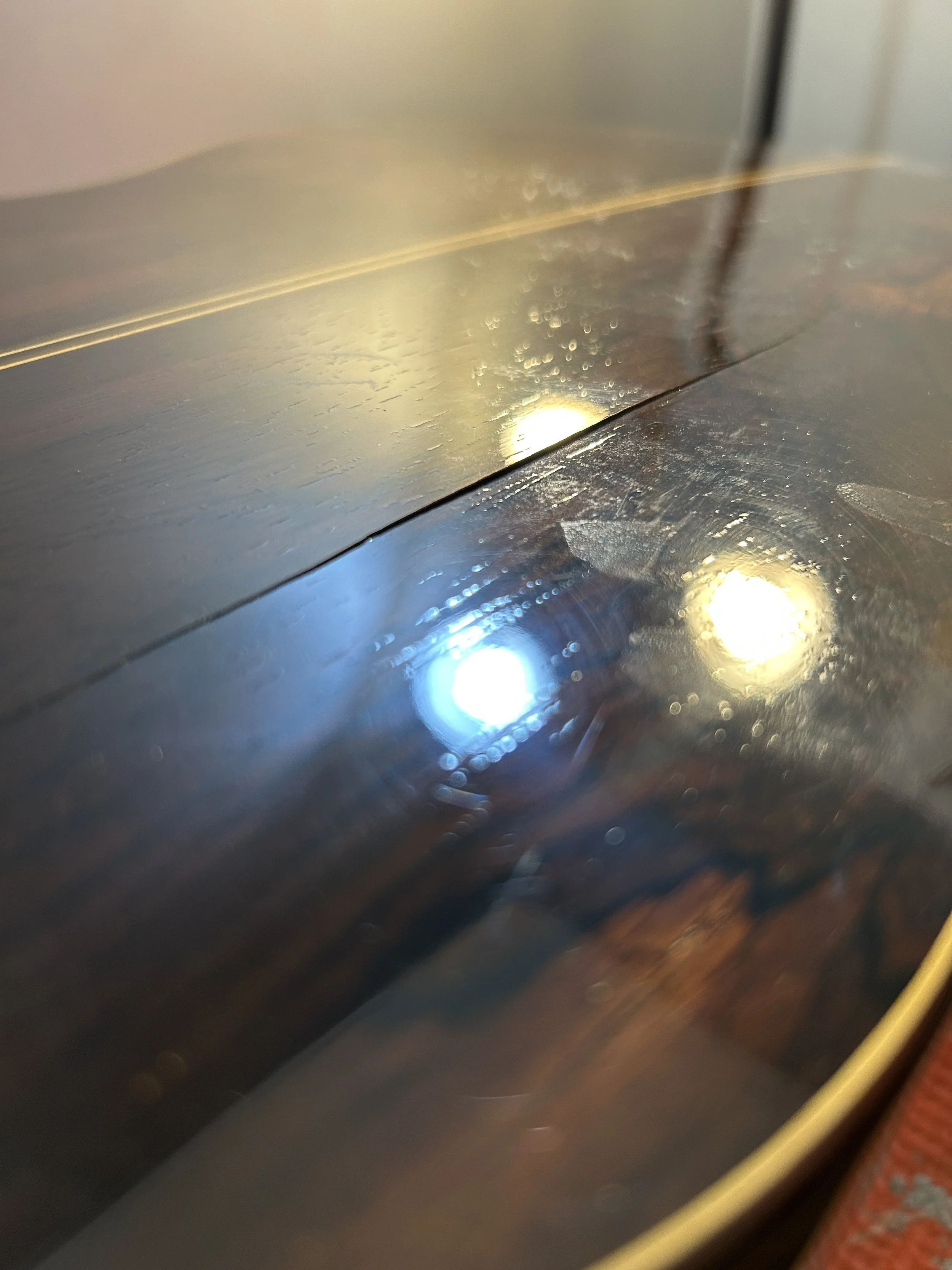 Close-up of the surface of a big crack on the back of a guitar made of Brazilian rosewood.