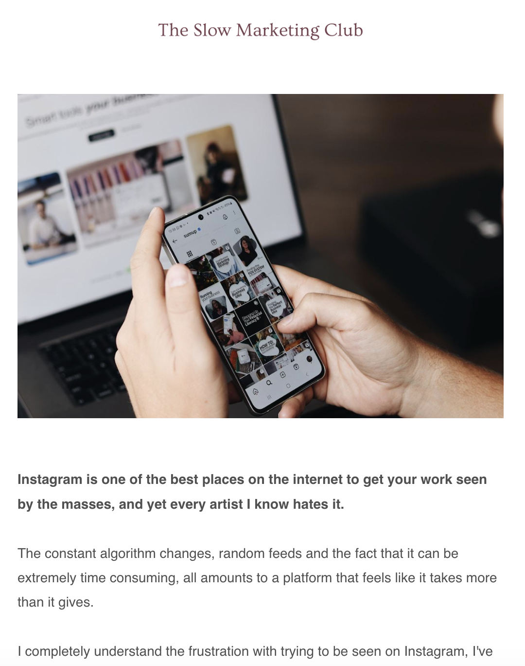 Person holding a smartphone with Instagram app open, displaying images and videos, in front of a laptop showing a website.