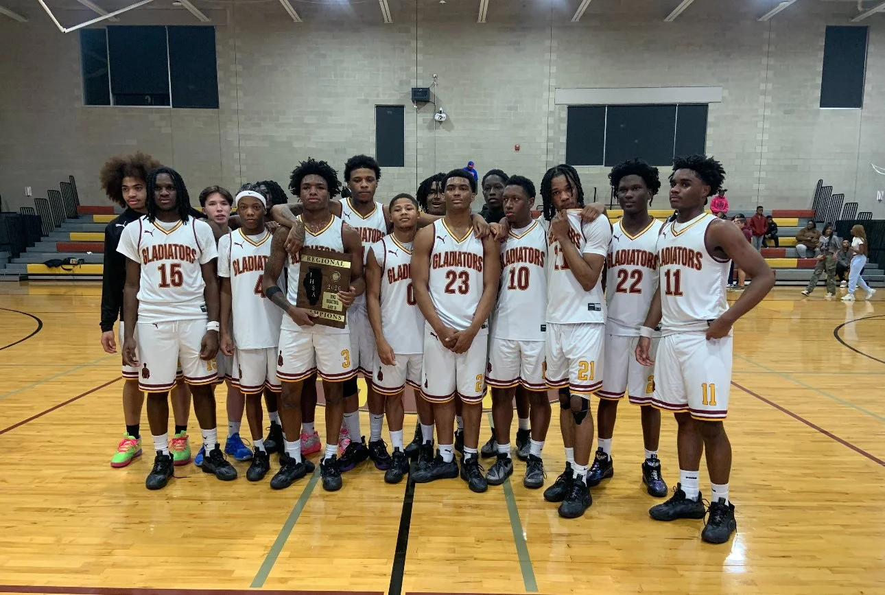 A youth basketball team named Gladiators in white uniforms with red and gold details, posing in a gymnasium with some players holding a championship plaque.