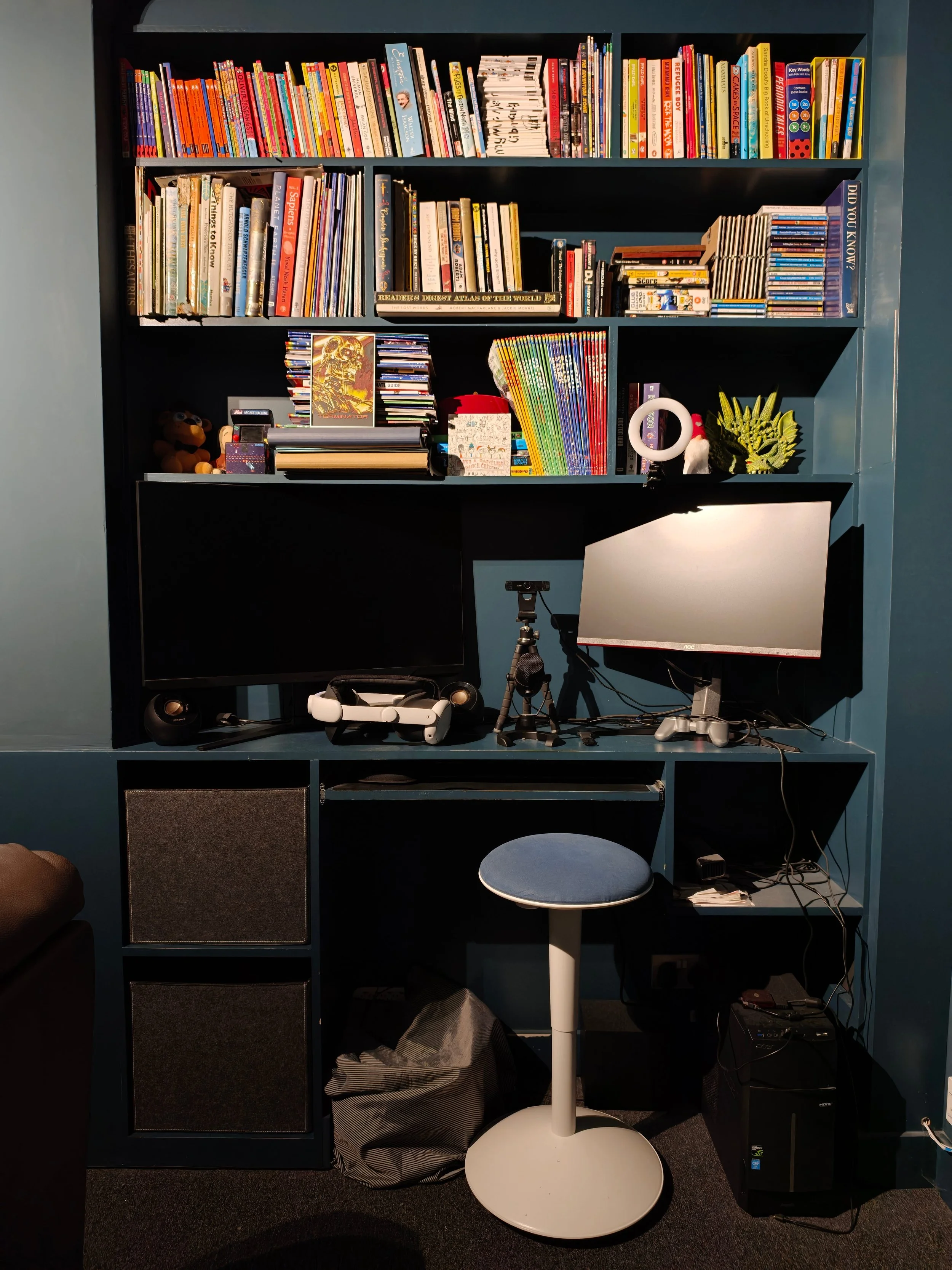 Library snug with bespoke floor to ceiling made bookcase, dark interior design paint, timber floor.