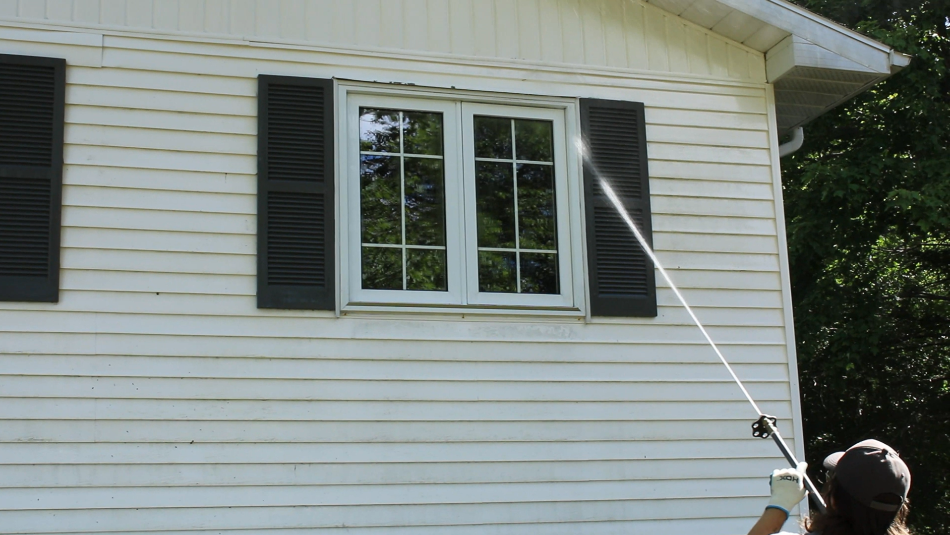 Clean Air Atlantic technician performing an exterior home softwash