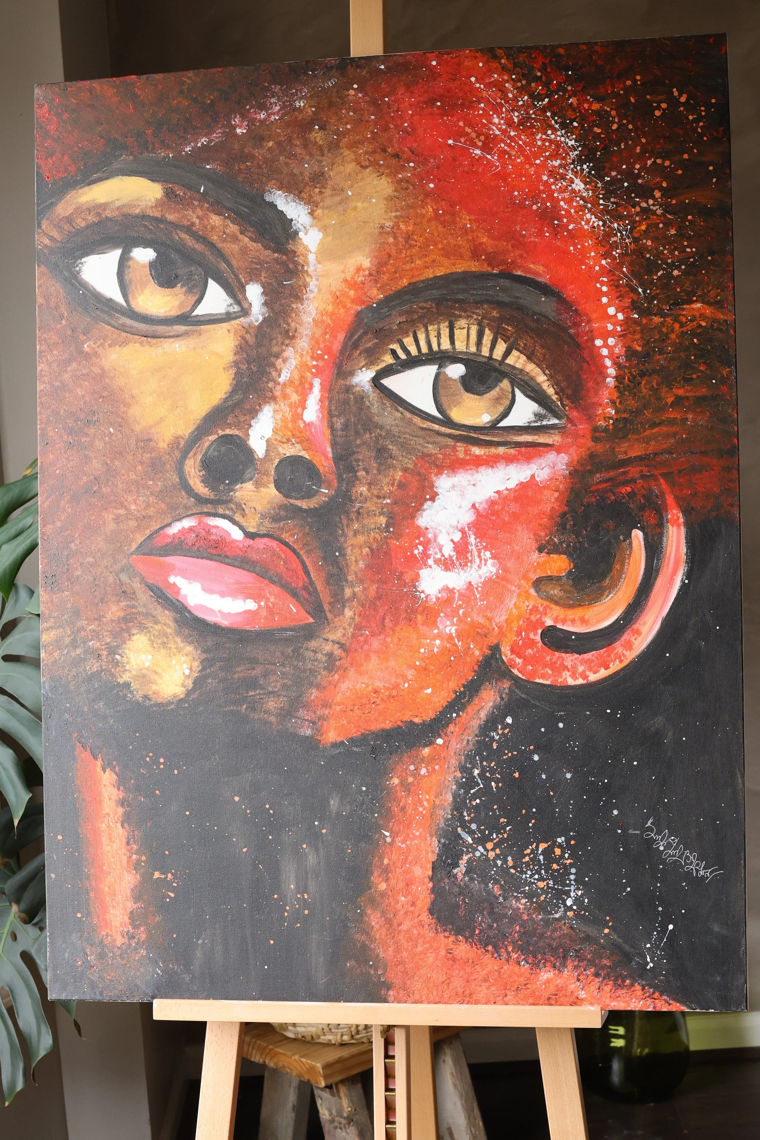 A painting of a woman's face with warm tones, featuring detailed brown eyes, full lips, and abstract splashes of white and orange on a dark background.