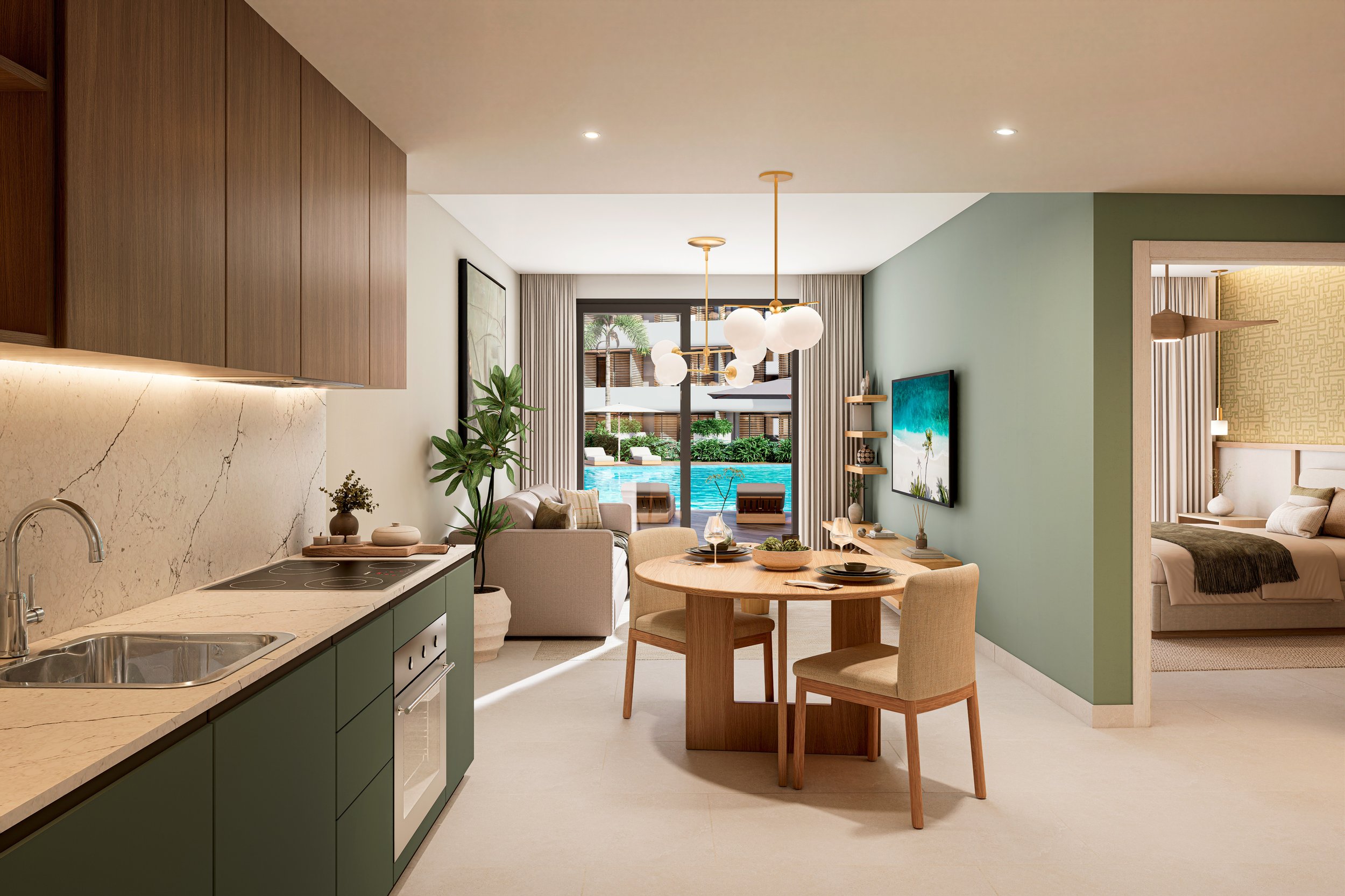 Interior de una sala y comedor de un departamento con vista a la piscina, cocina moderna con encimera de piedra y gabinetes verdes, comedor con mesa de madera y sillas beige, sala con sofá y plantas, habitación en el fondo con cama y decoración moderna.