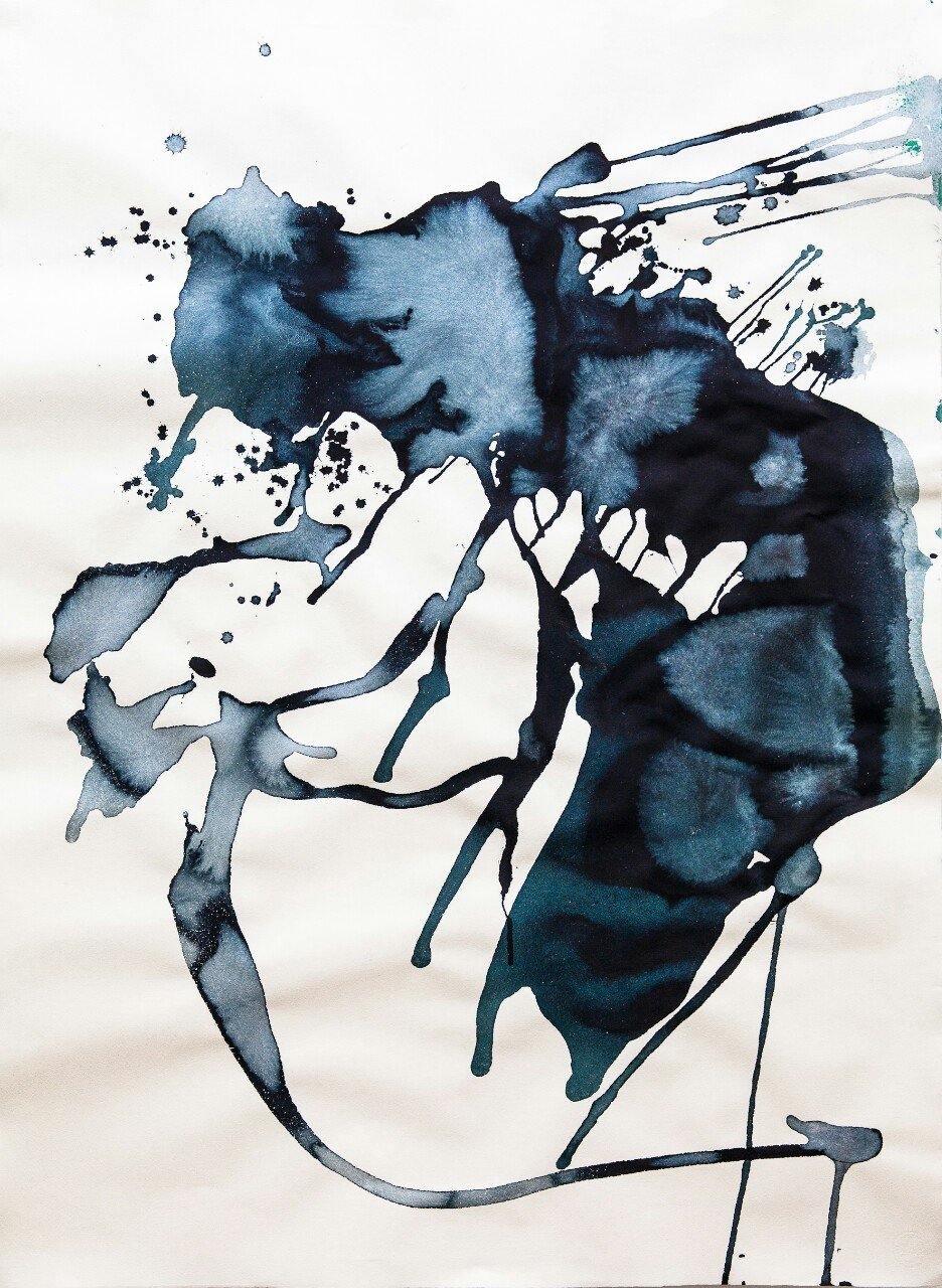 Abstract watercolor painting with black and dark blue ink splashes on white paper