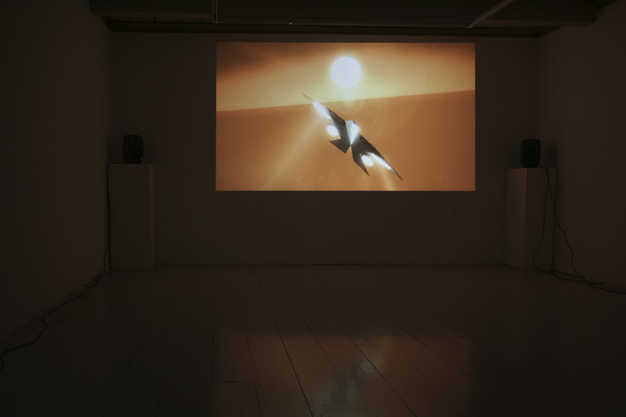 A spaceship flying against a sunset background with a large sun and a desert landscape.