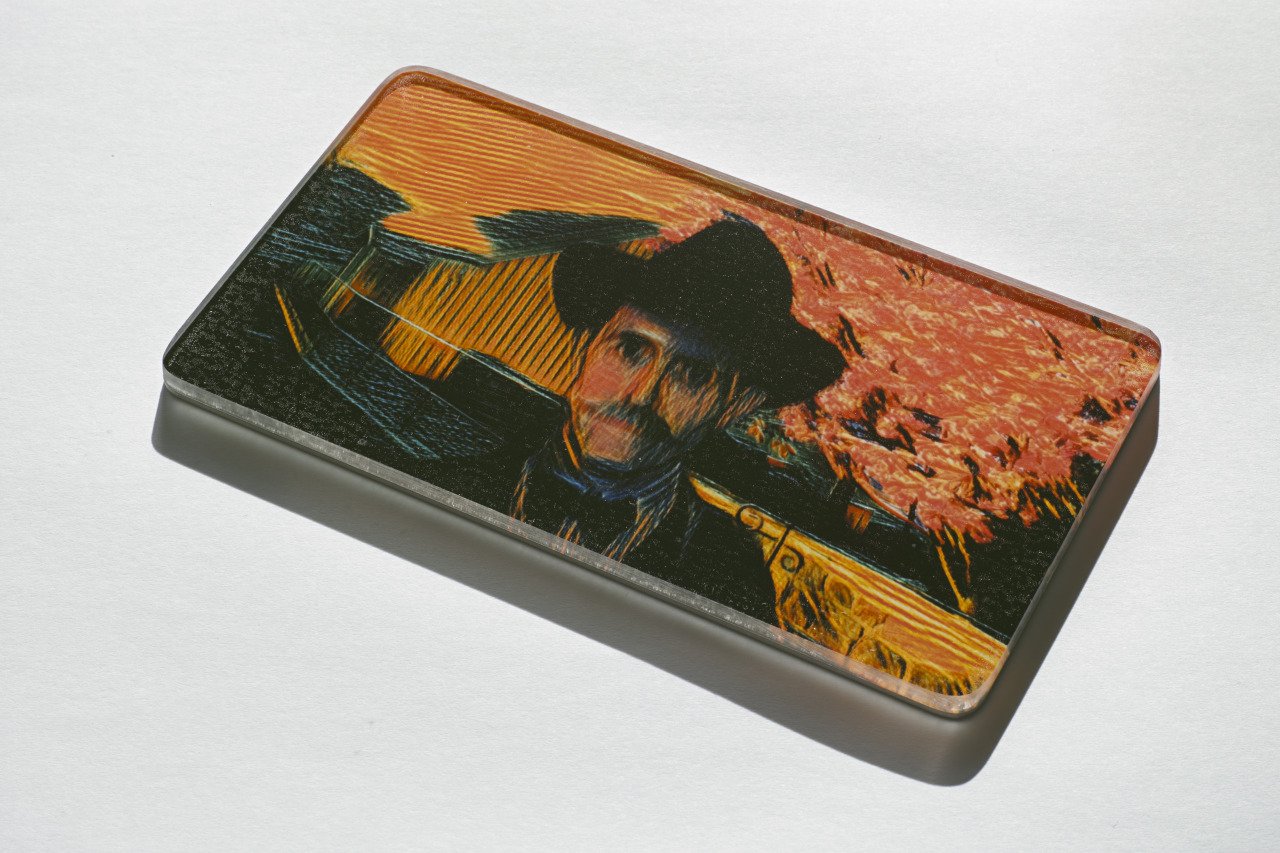 A rectangular object with a colorful illustration of a dog and a sunset on its surface.