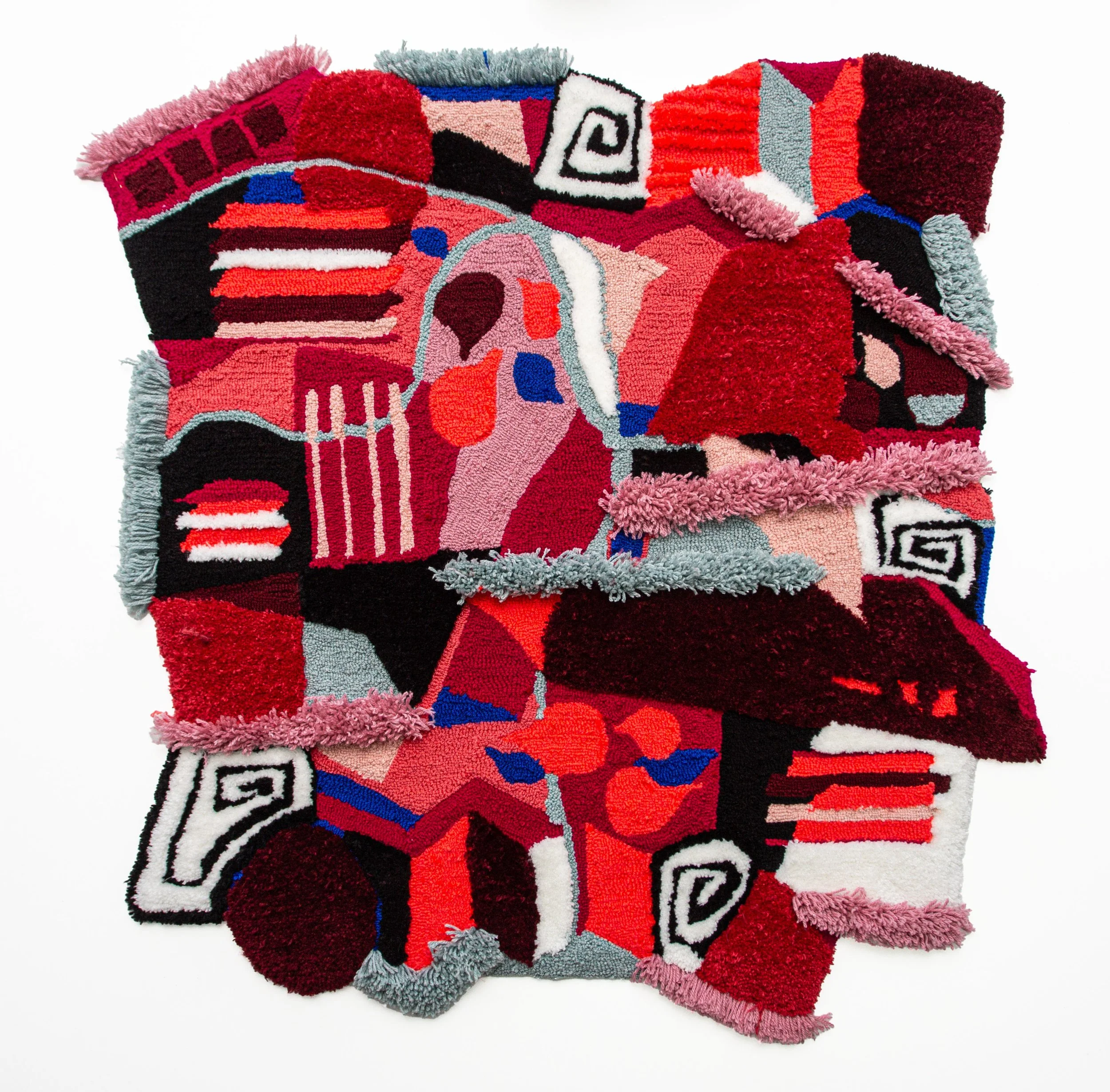 Colorful abstract textile artwork with various geometric shapes and patterns in shades of red, pink, black, white, blue, and gray.