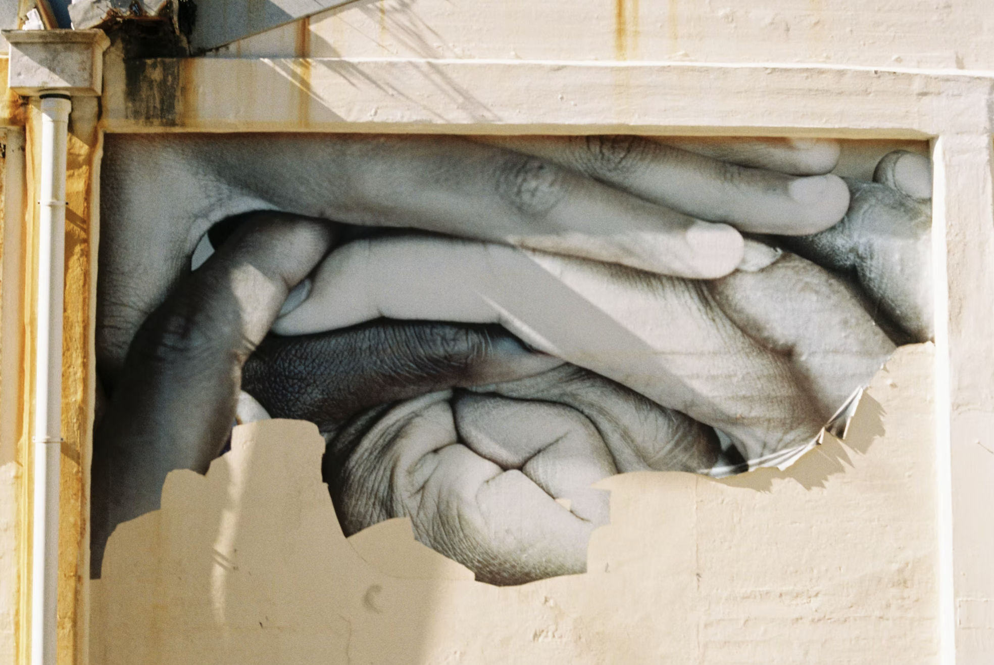 Black and white photo of disembodied hands and mouth making a gesture.