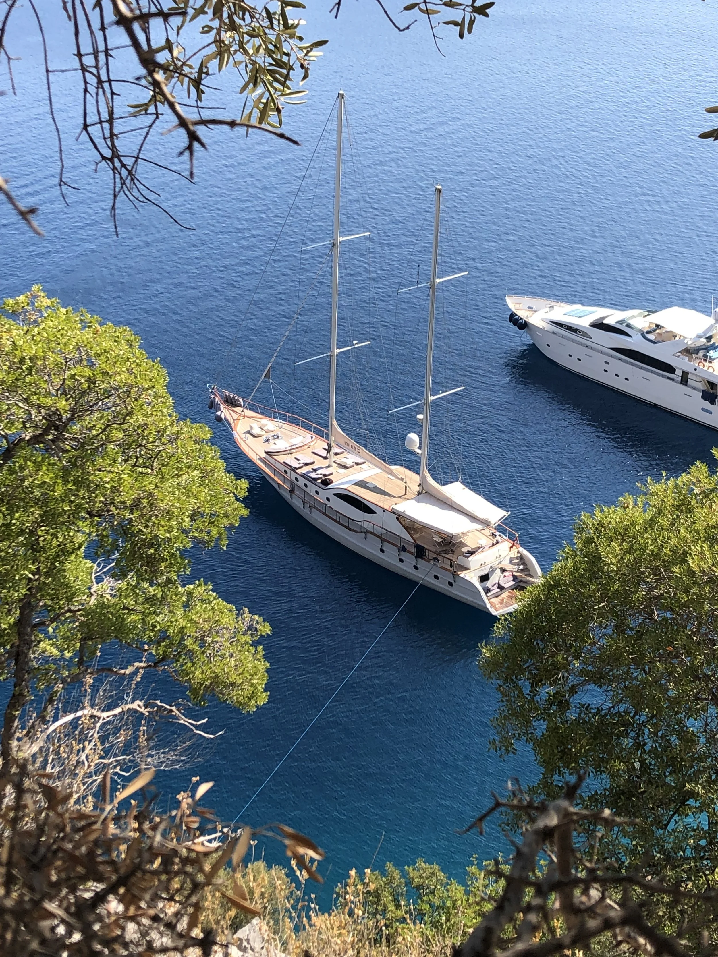 Yalıkavak Marina in Bodrum featuring luxury superyachts, golden beaches, designer boutiques, waterfront restaurants and stunning Aegean coastal scenery.
